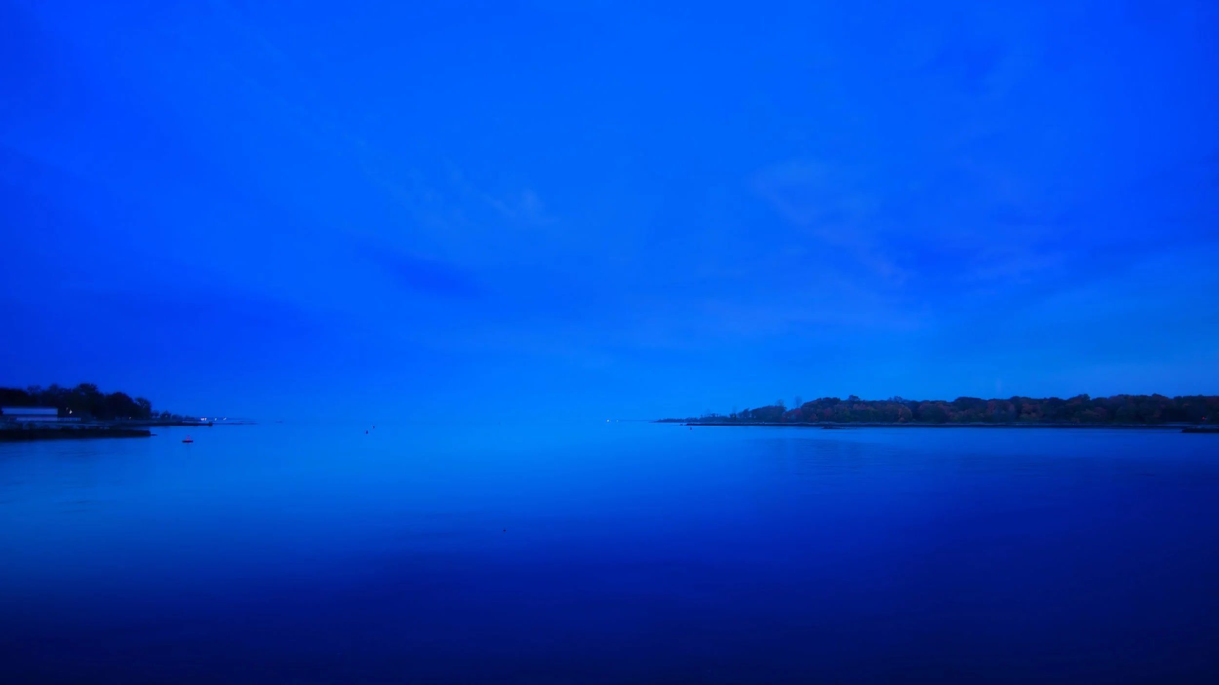 View of the calm harbor waters at twilight at Glen Island Harbour Club
