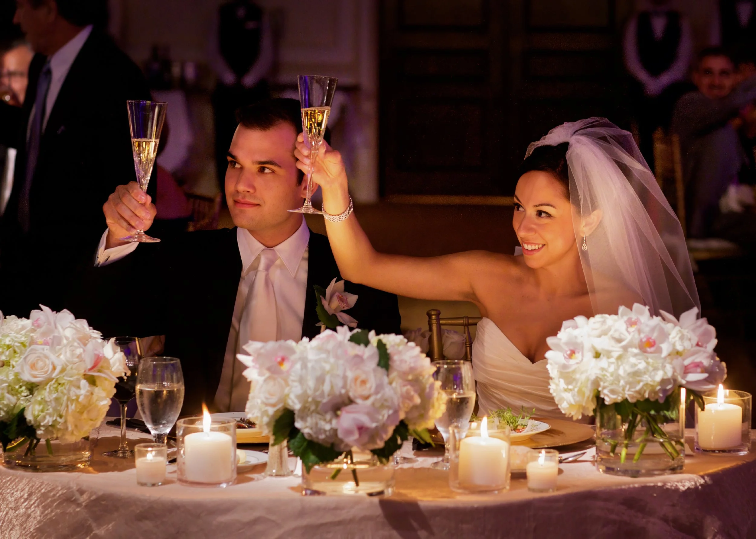 Bride and groom raising glasses during their wedding toast at the Omni Hotel New Haven.