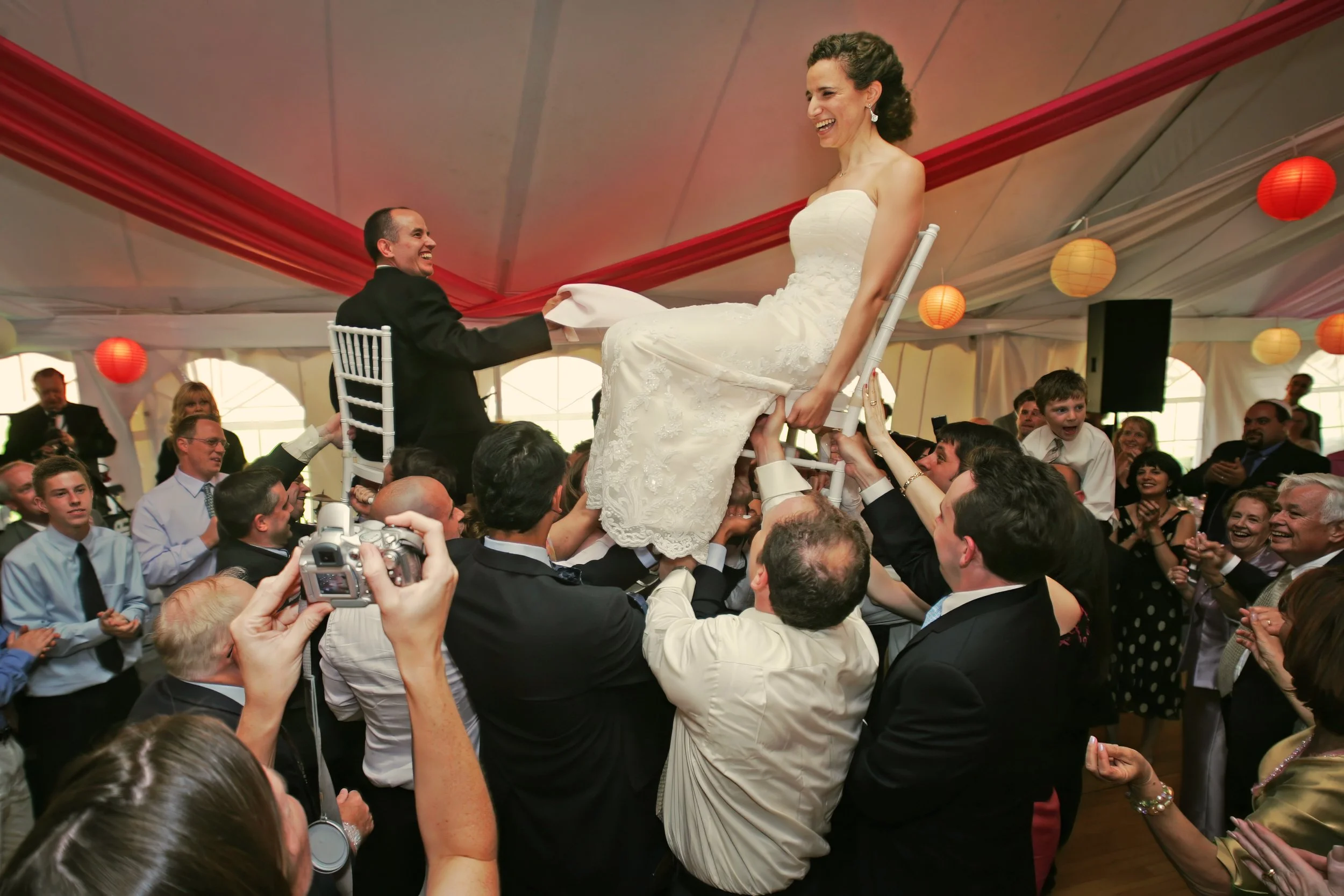 Bride and groom dancing during hora at outdoor wedding reception Spa at Norwich Inn Connecticut