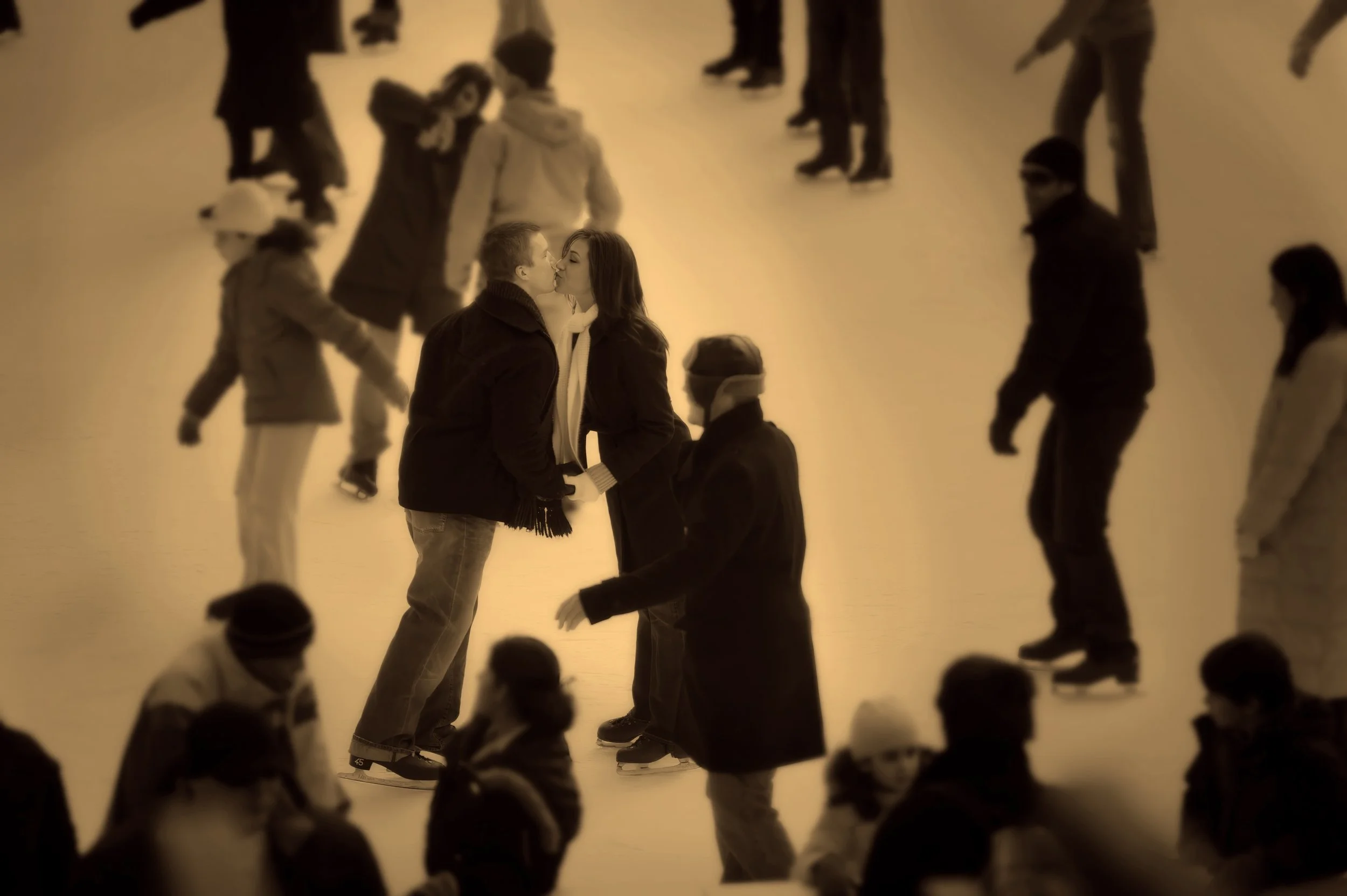 Couple kissing on ice at Wollman Rink during a Central Park engagement session