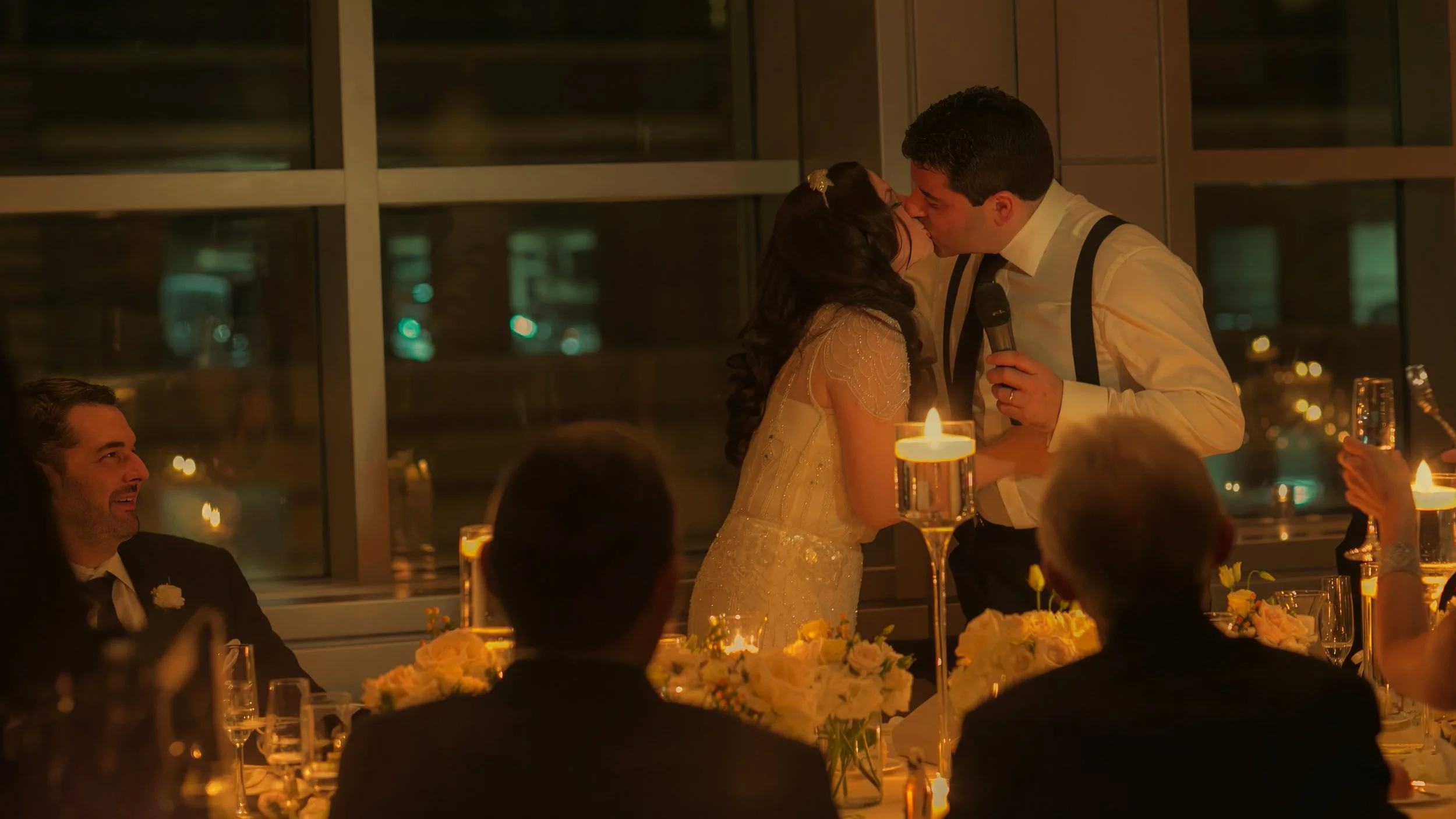 Bride and groom share a romantic kiss following a heartfelt wedding toast in the ballroom at W Hoboken.