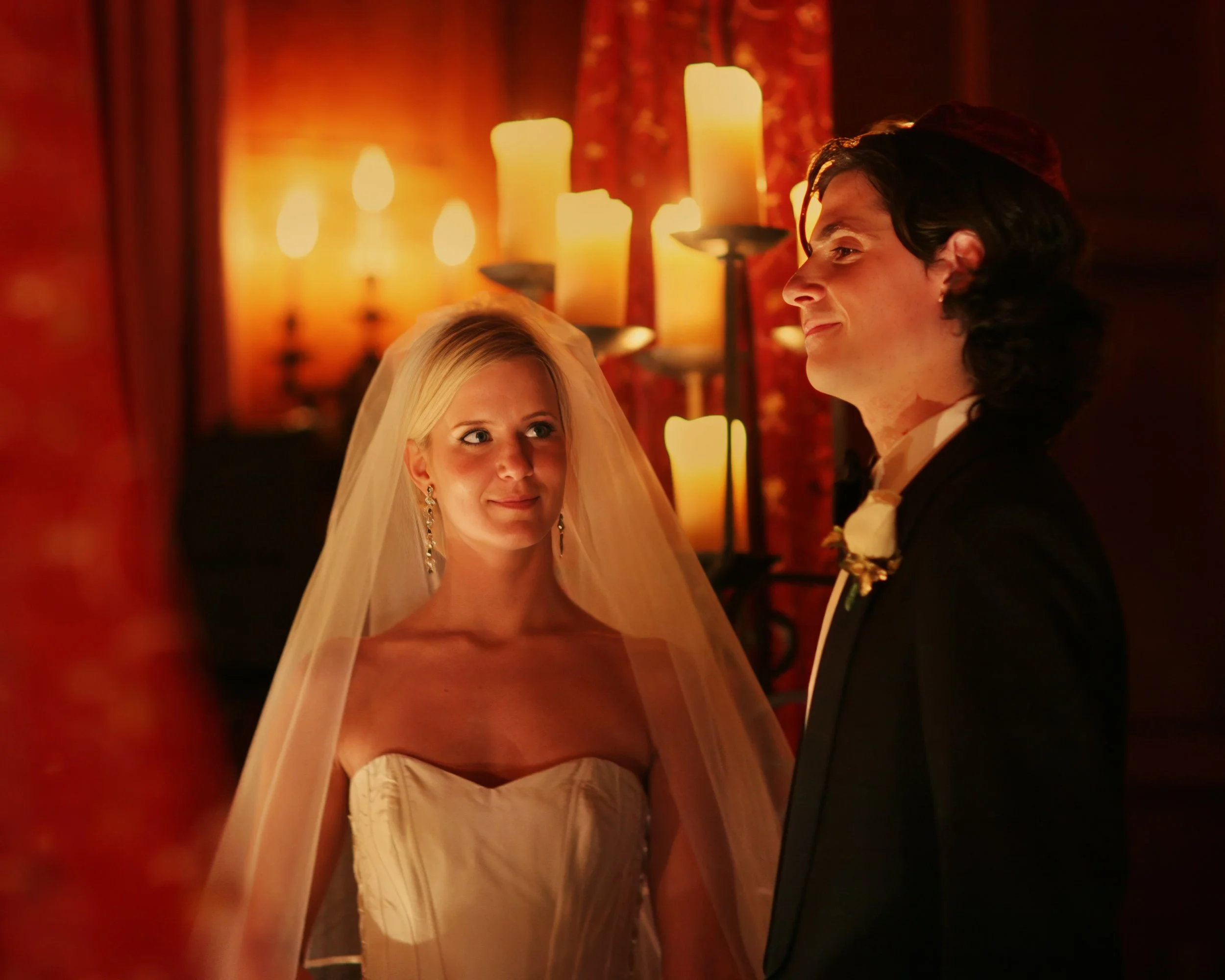 Bride and groom during a candlelit wedding ceremony at The Harmonie Club, creating a warm and intimate atmosphere.