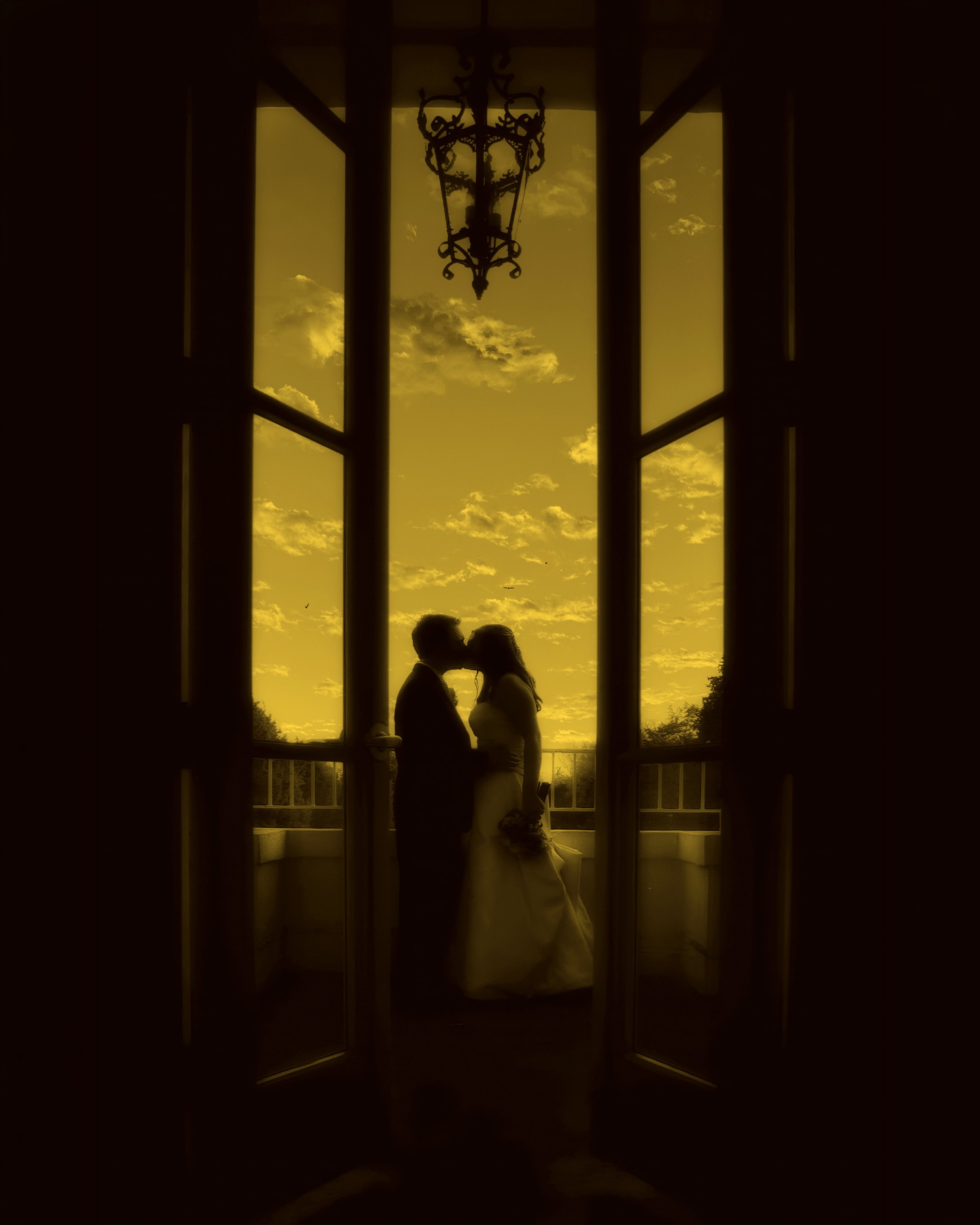Bride and groom kissing in silhouette during sunset at Wadsworth Mansion in Middletown, Connecticut.