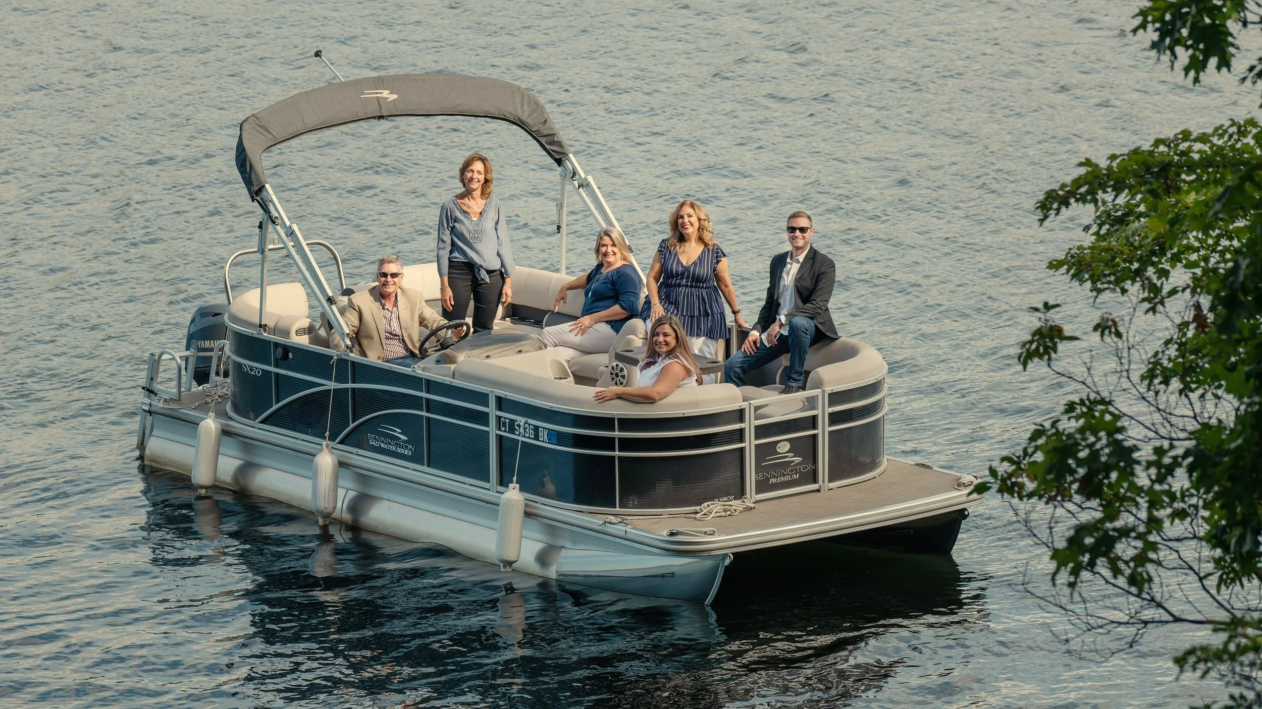 Family portrait on a pontoon boat at a Connecticut Lake House