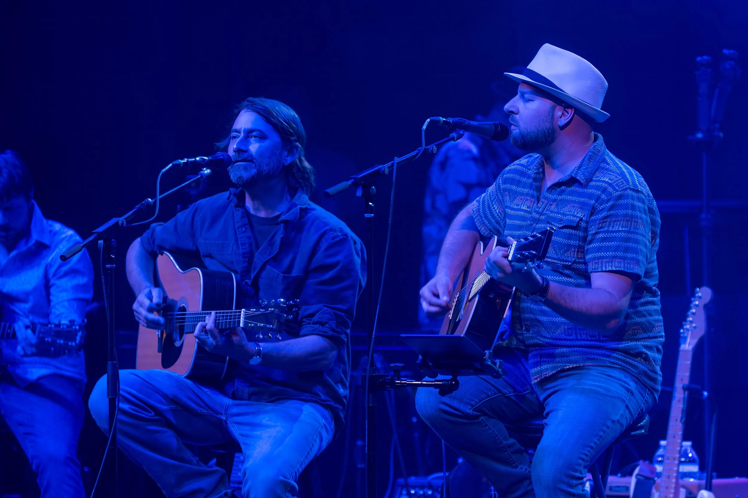 Matt Eckstine and Eric Daubert playing acoustic guitars together during a live tribute concert in Savannah area