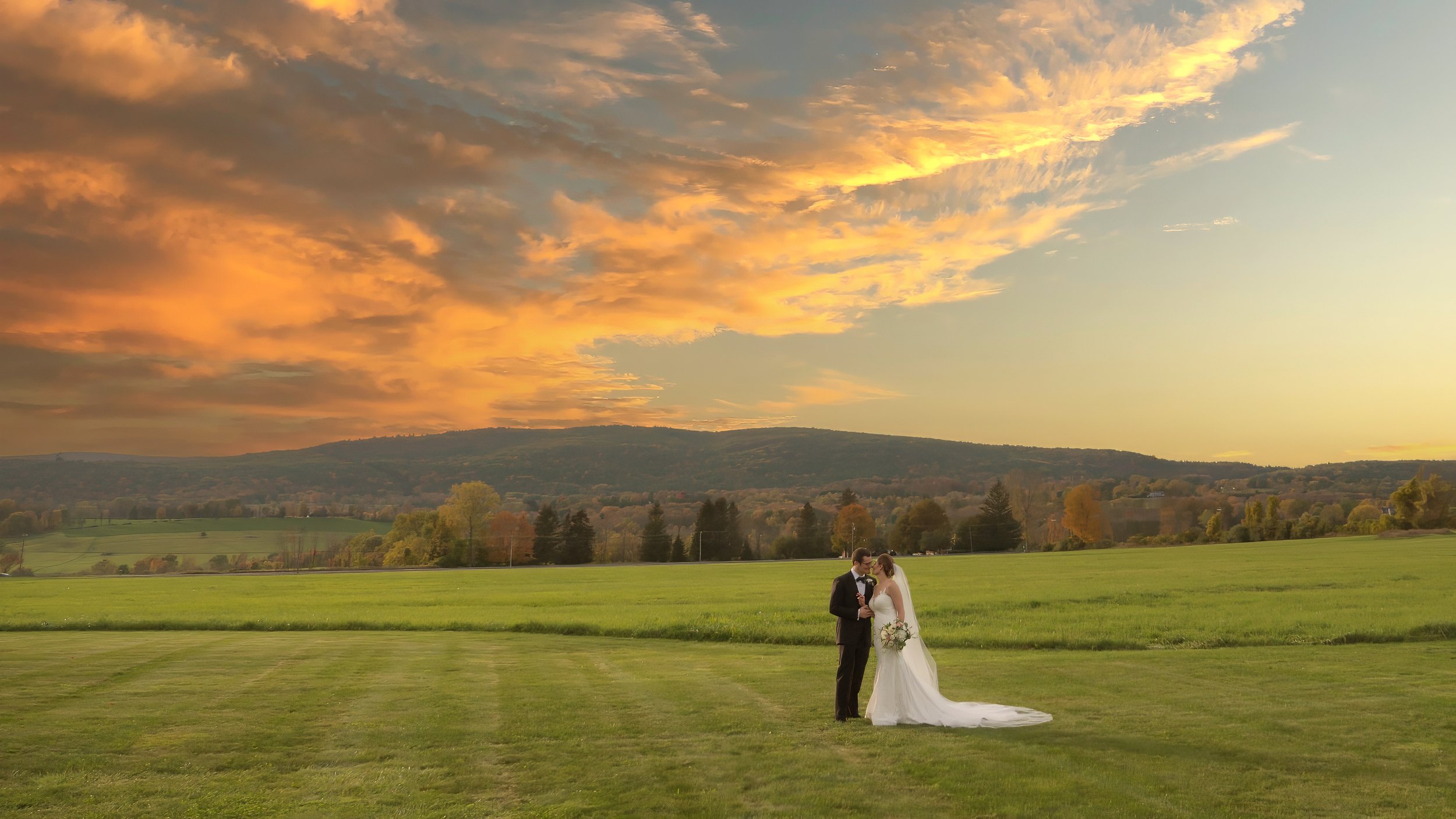 Bride and groom sharing romantic portrait overlooking Litchfield Hills at Lion Rock Farm
