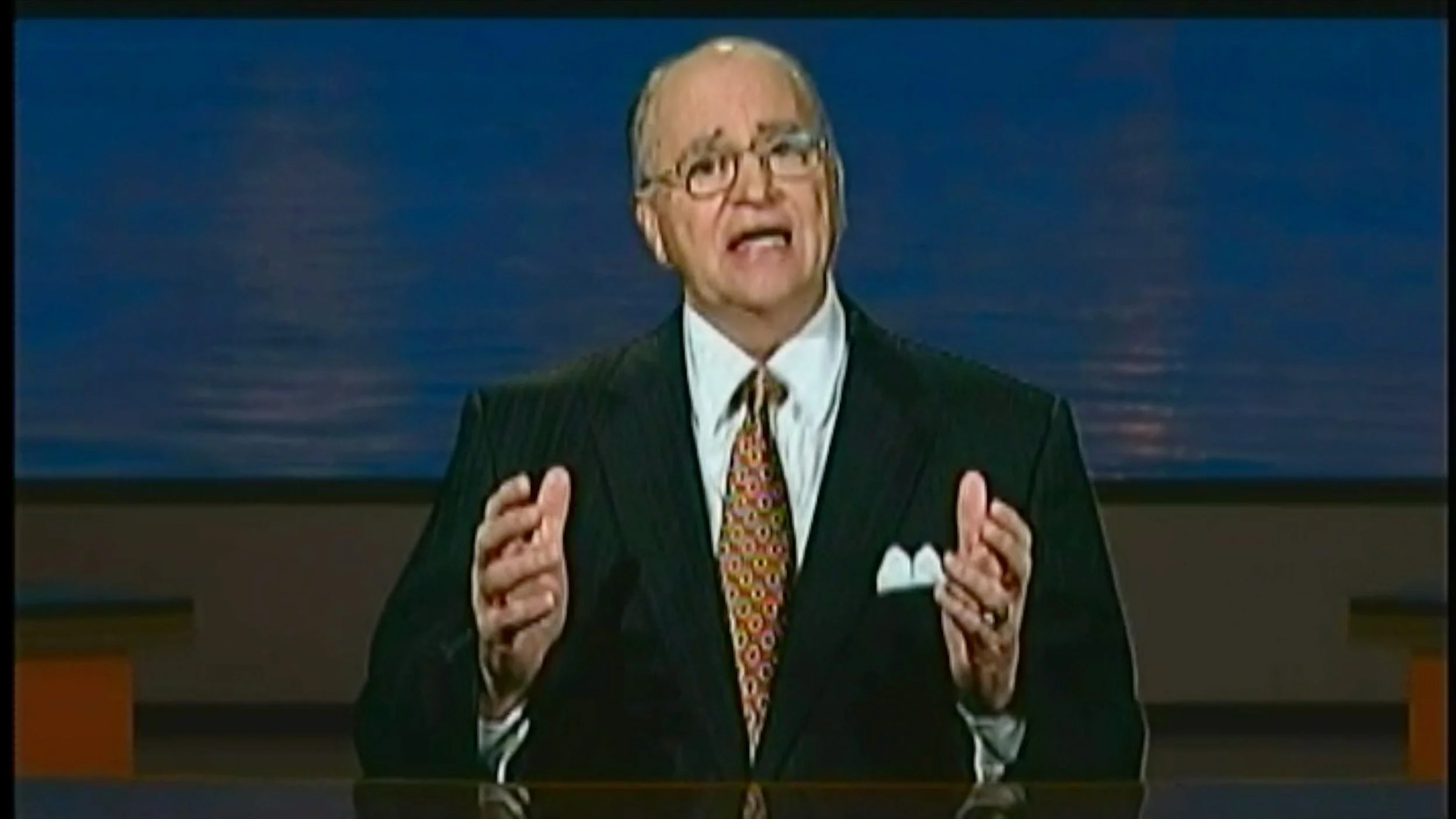 Archival recording of a church preacher speaking at a lectern, used as historical footage in the South Gastonia Church of God documentary.