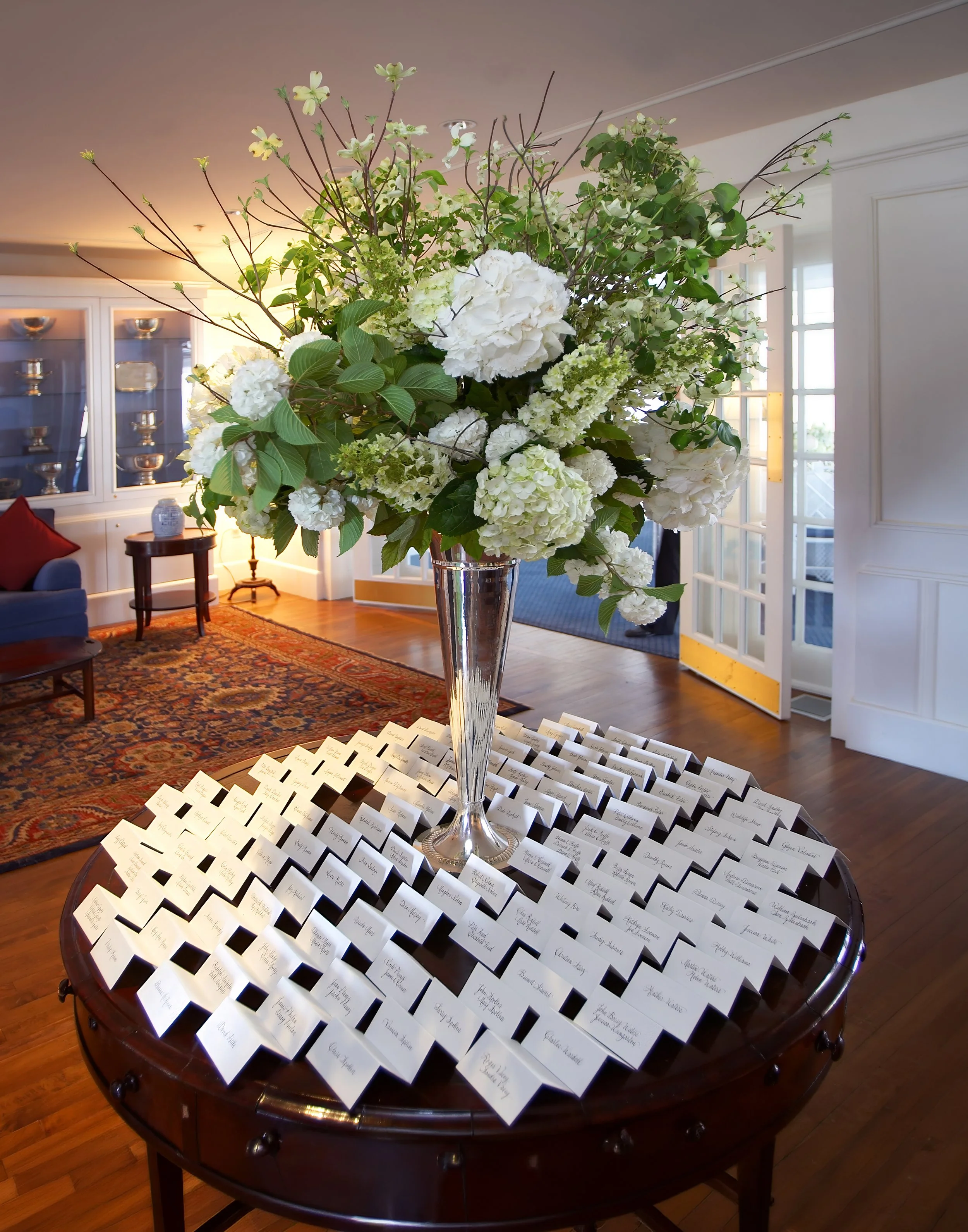 Foyer floral arrangements and seating card table at Belle Haven Yacht Club wedding reception.