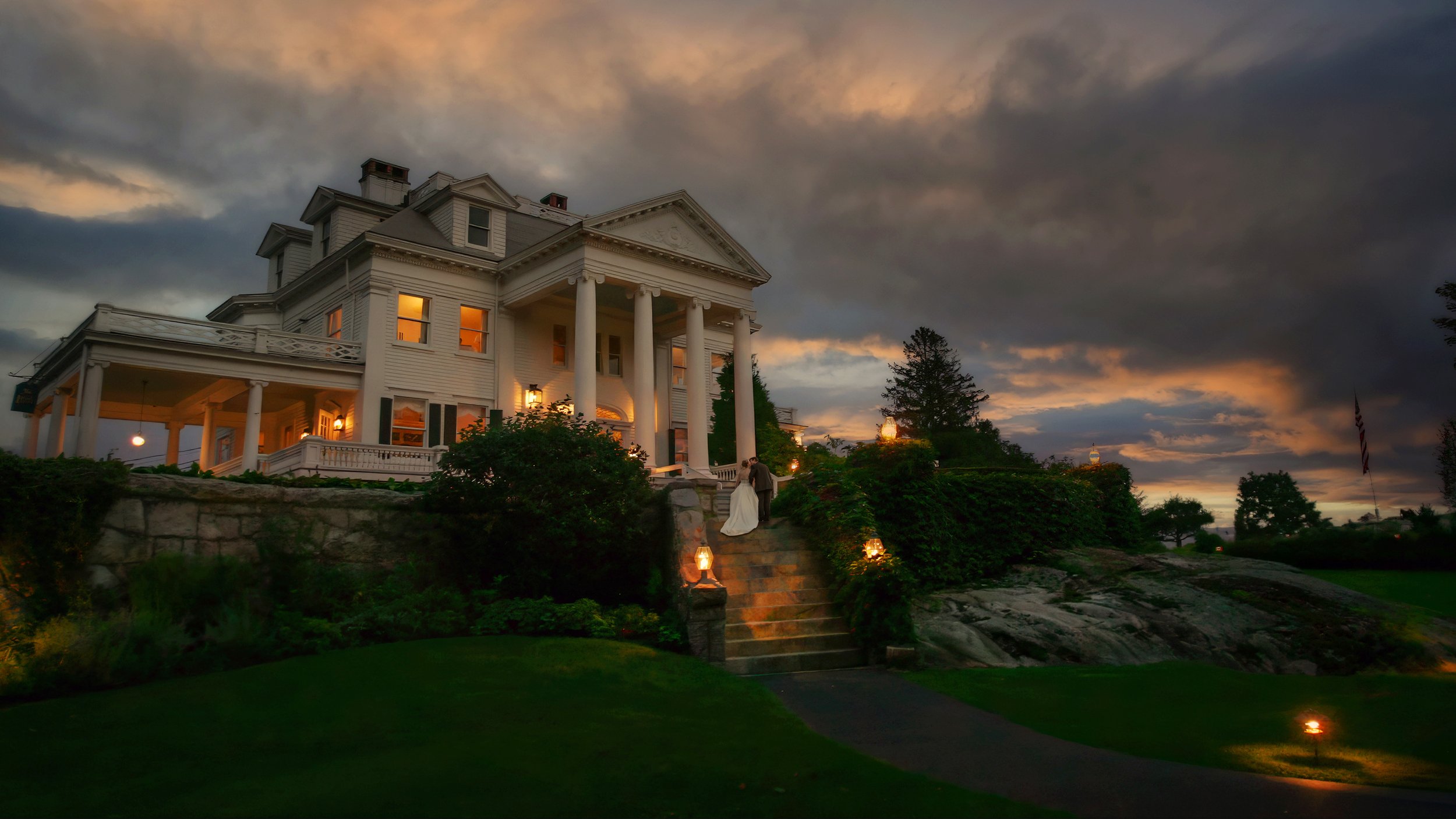 Bride and groom walking up stone steps at Haley Mansion during Inn at Mystic wedding in Connecticut