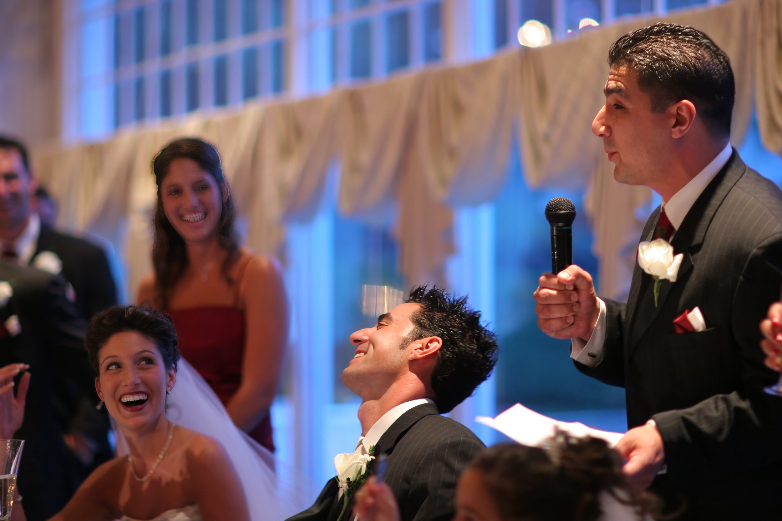 Guests raising glasses in a joyful toast during a wedding reception at Aqua Turf Club in Southington Connecticut.