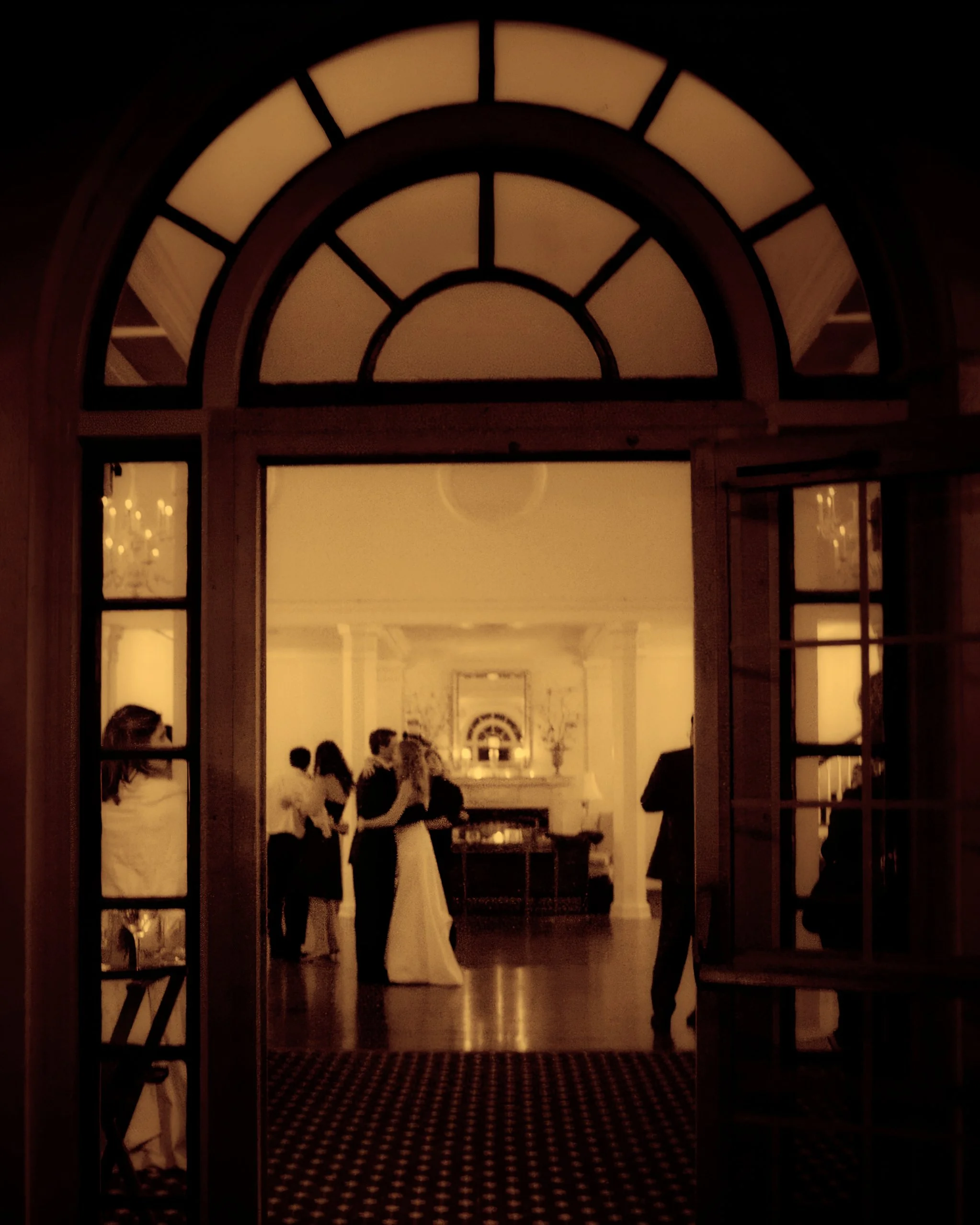 Bride and groom share a last dance framed by the architecture of Siwanoy Country Club.