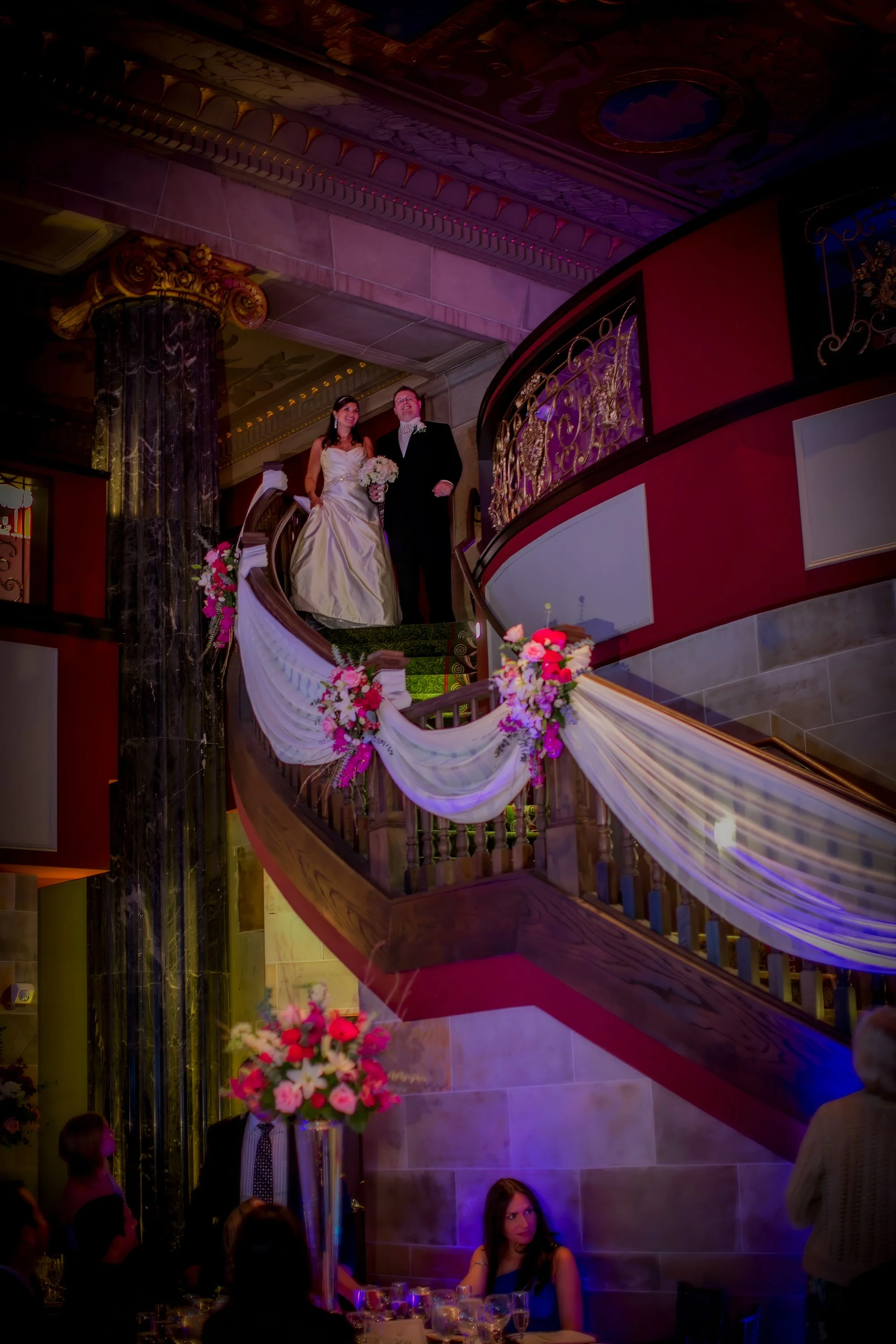 Bride and groom descending the grand staircase into the ballroom at The Society Room of Hartford.