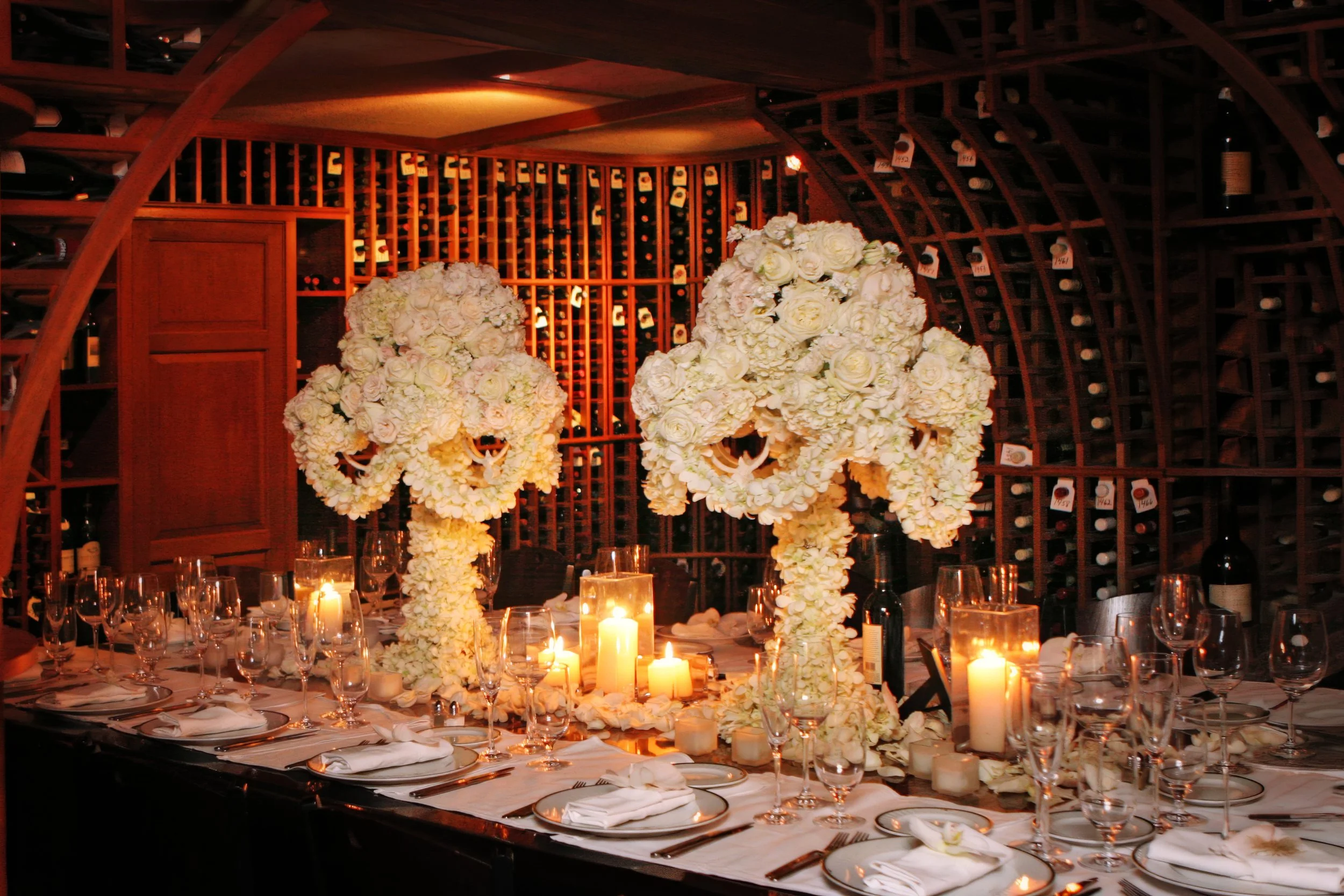 Lavish floral decor in an intimate wedding reception held in the wine cellar at Valbella in Riverside, Connecticut.