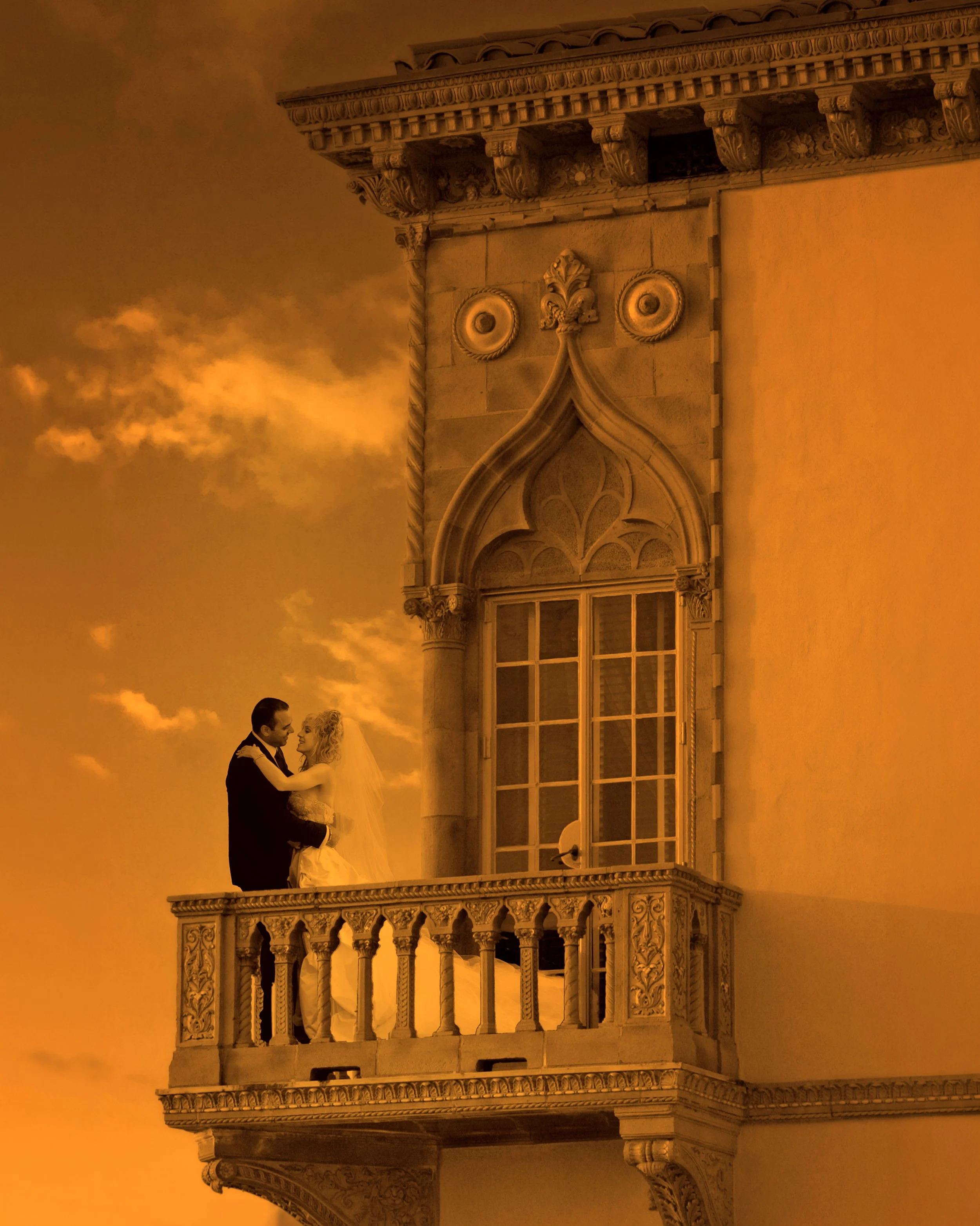 Bride and groom embracing on a balcony at Ca d'Zan
