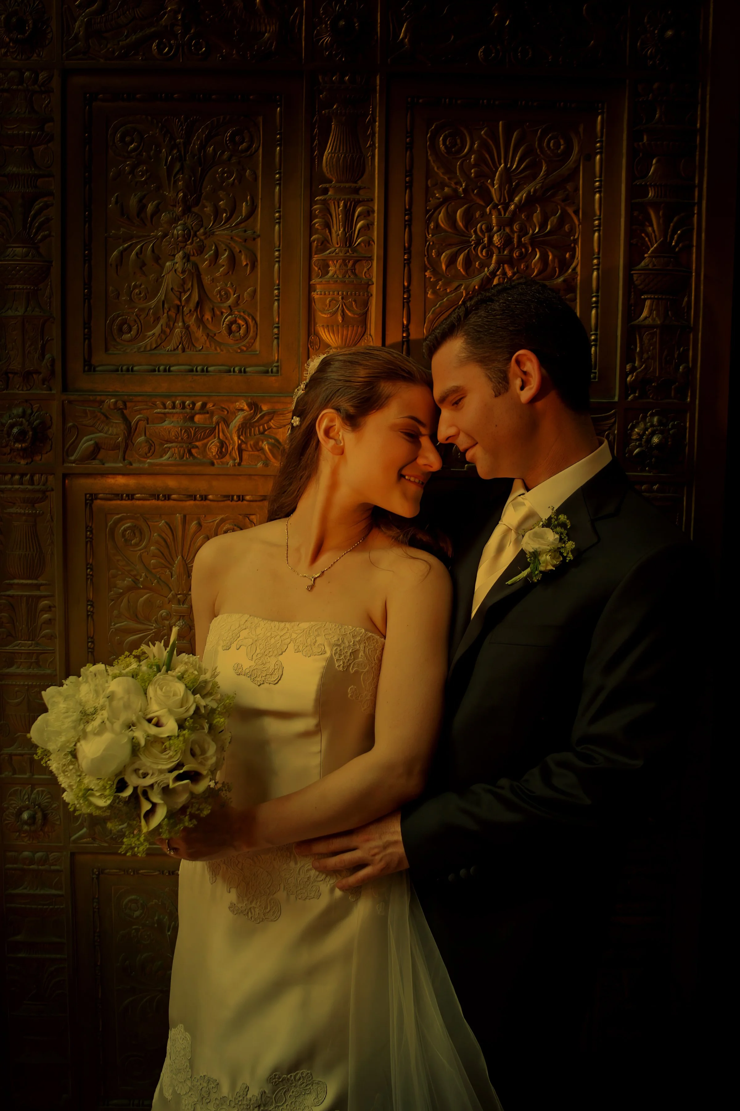 A romantic portrait agains the brass doors at Gotham Hall