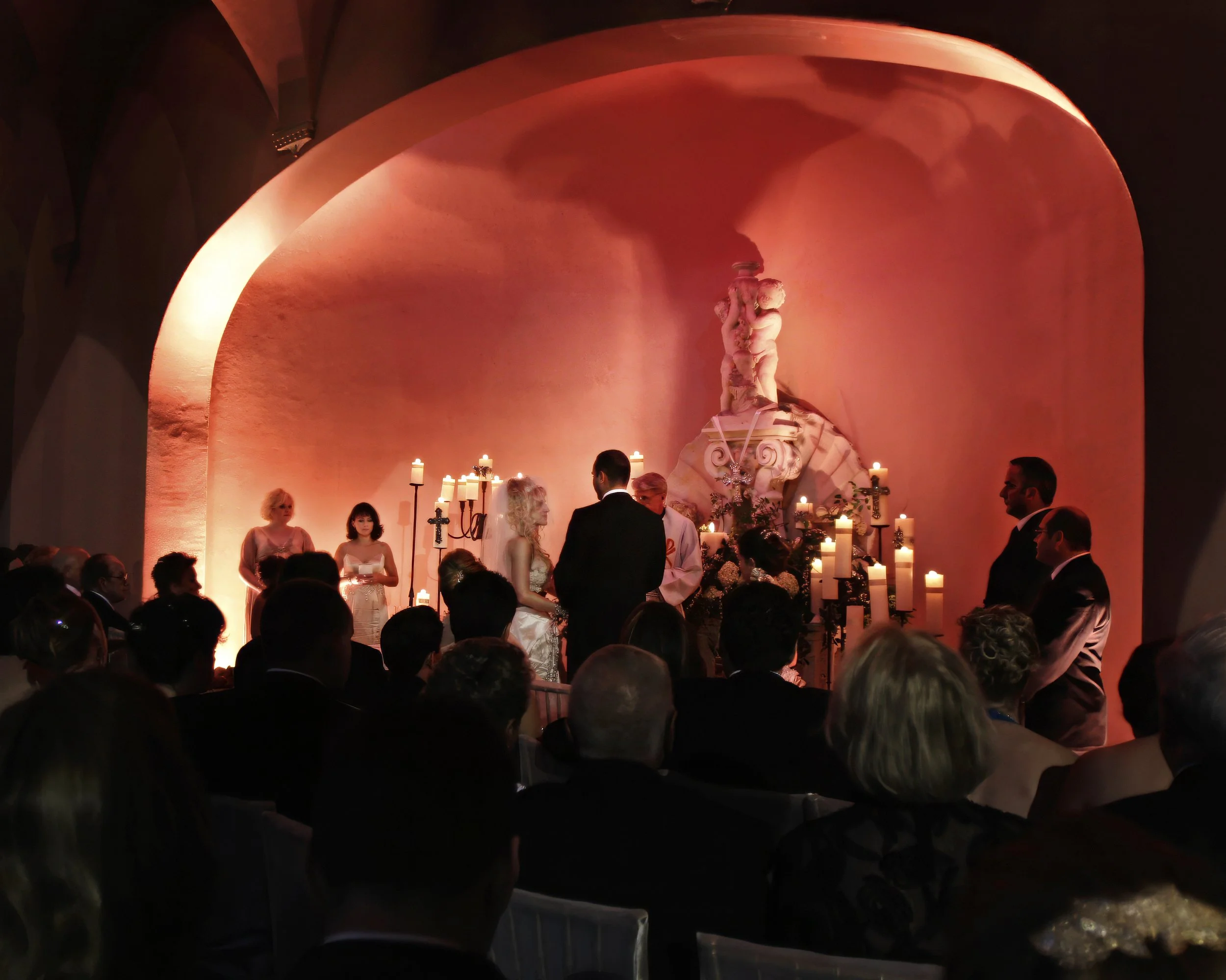 Bride and groom exchange vows during a candlelight outdoor wedding ceremony at The Ringling Museum in Sarasota, Florida.