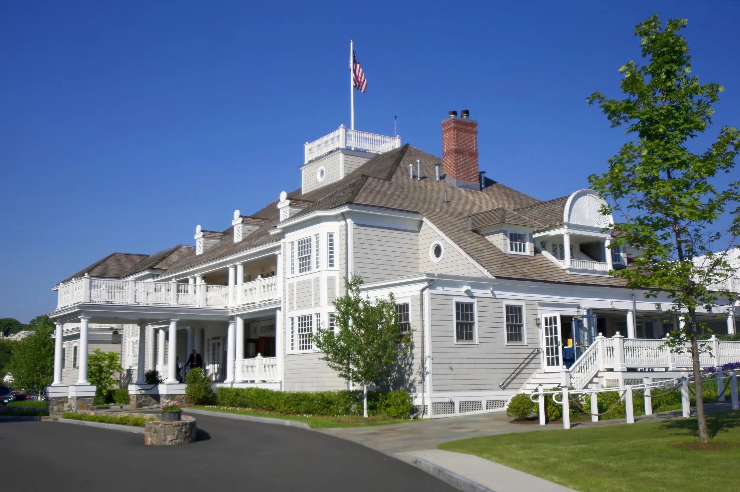 Exterior of Belle Haven Yacht Club under blue skies in Greenwich Connecticut.