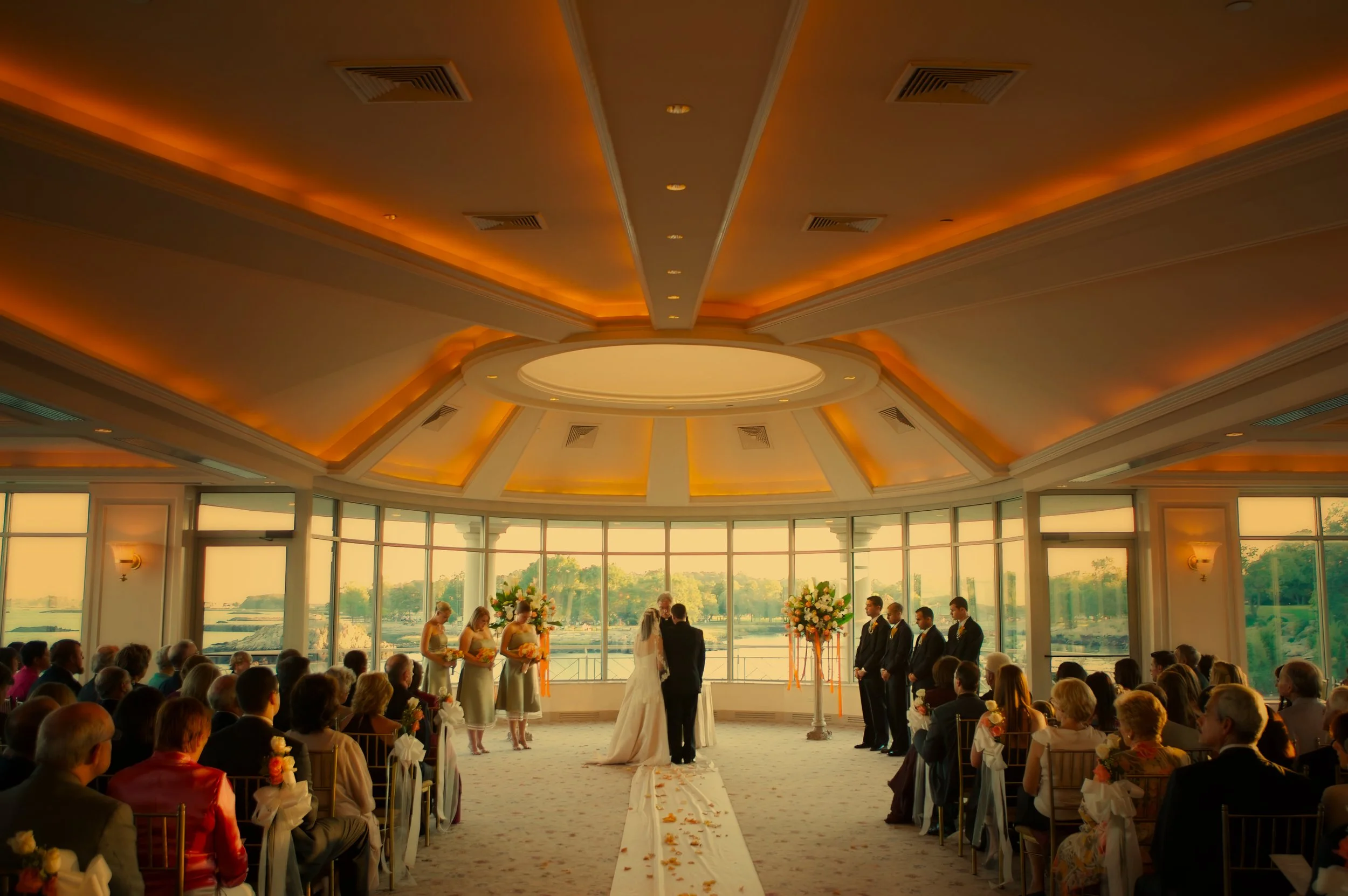Wide angle view of an indoor wedding ceremony at Glen Island Harbour Club
