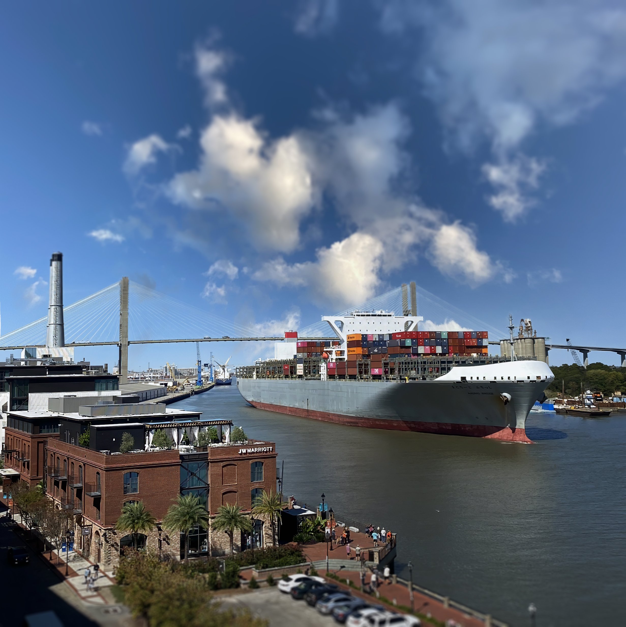 JW Marriott on the Savannah River with a cargo ship passing under the Talmadge Bridge, capturing the waterfront view during a corporate event.