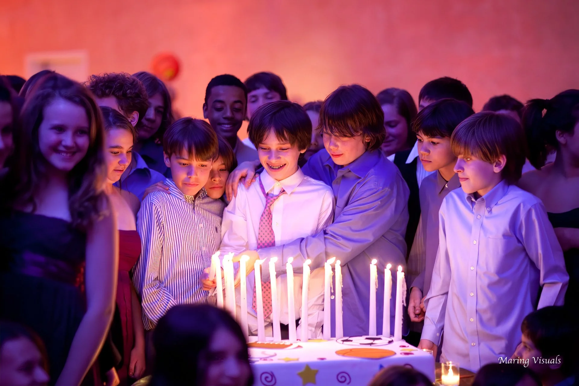 Candle lighting ceremony at a Bar Mitzvah in New York City surrounded by friends and family.
