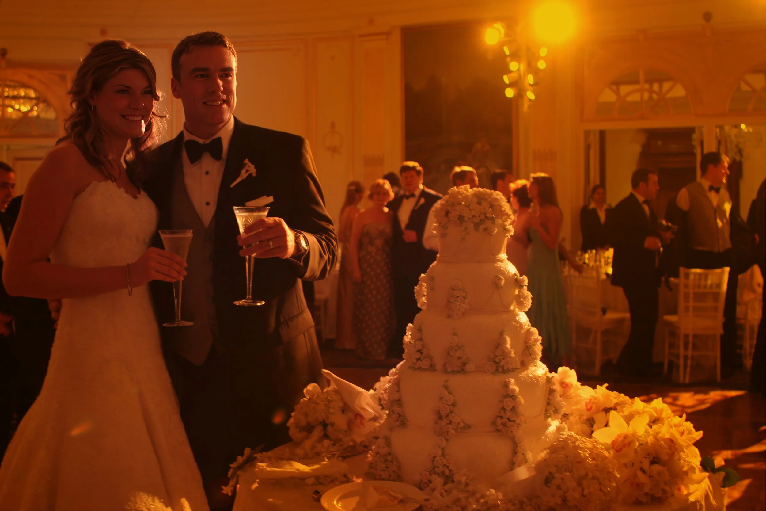 The bride and groom toast after cutting their wedding cake at the New York Palace Hotel