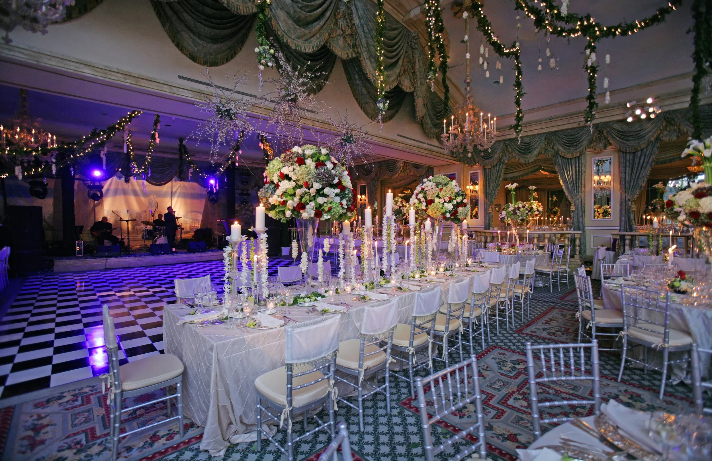 Grand Ballroom at The Pierre Hotel NYC set for a lavish wedding reception with tables, floral, and lighting