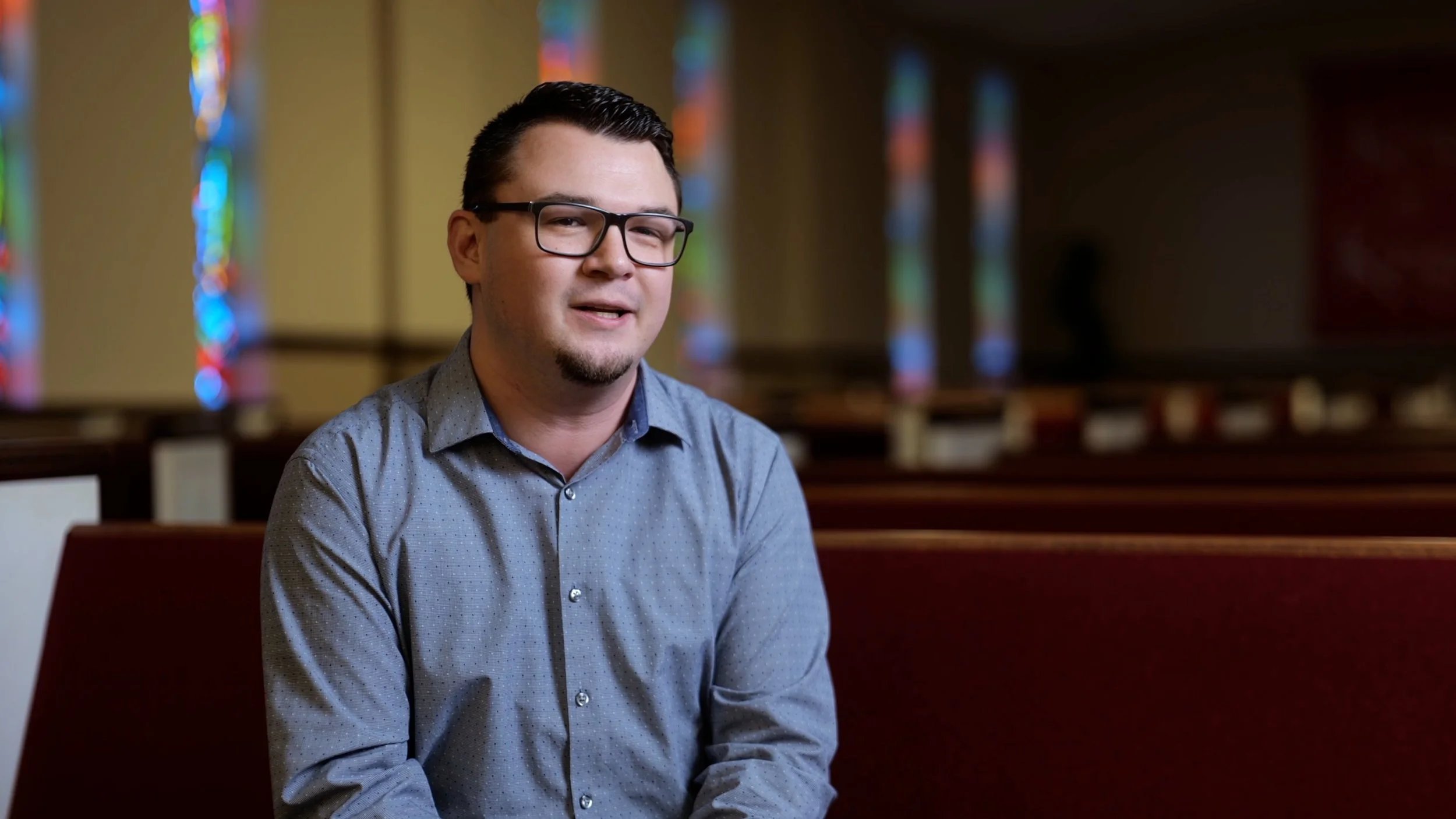 Pastor Adrian Franklin speaking during a cinematic church documentary interview inside the sanctuary at South Gastonia Church of God.