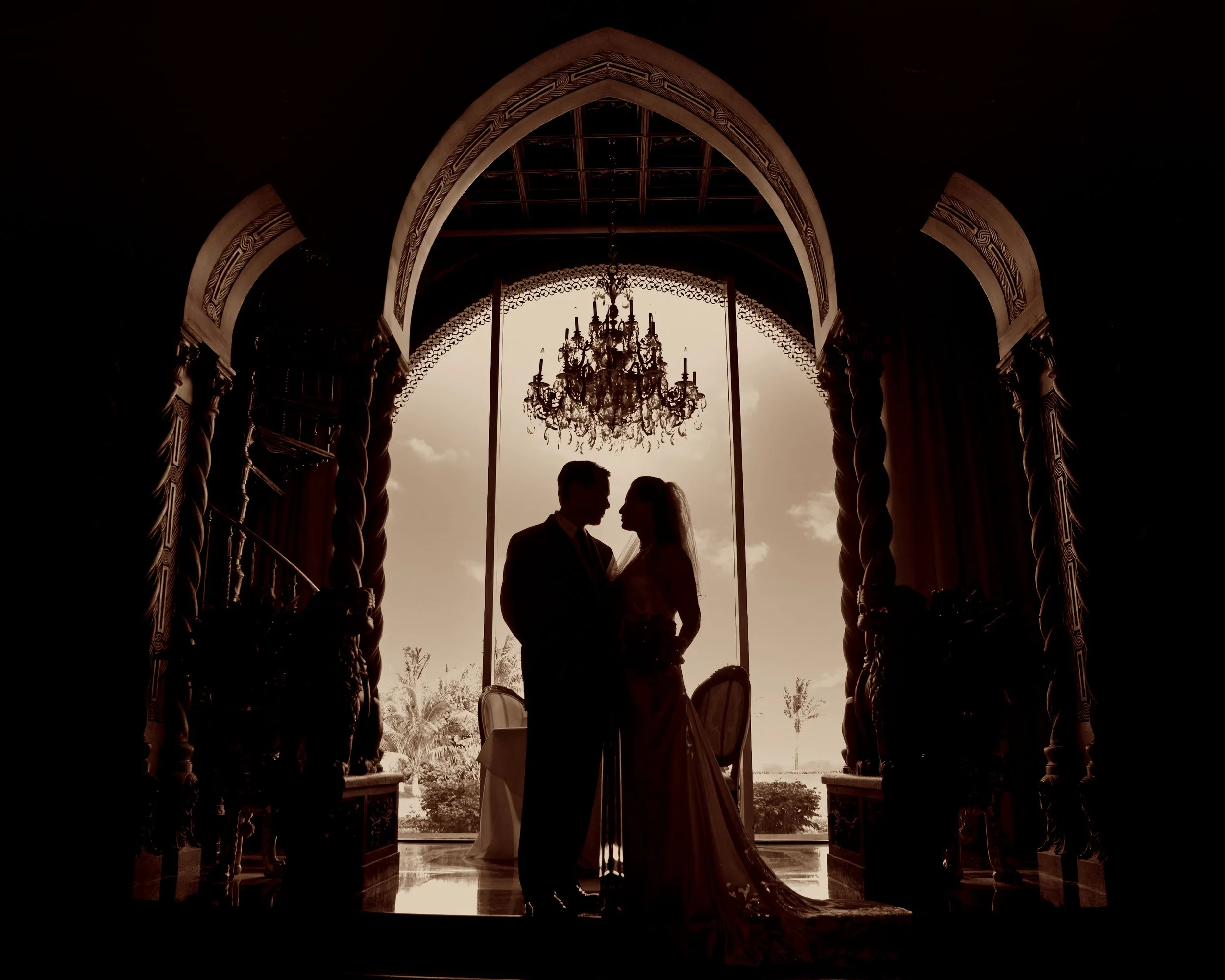 Bride and groom framed in the archways at a Mar-a-Lago Club Wedding