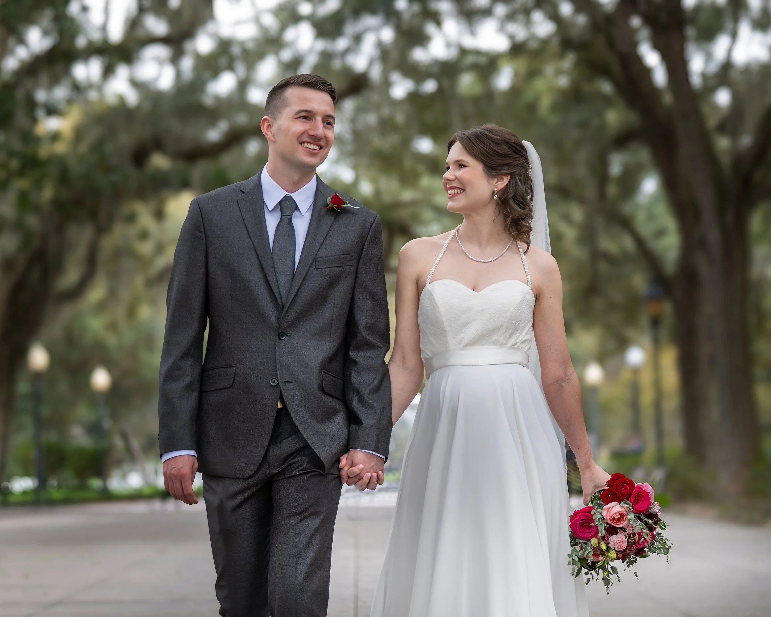 Tim and Daniella walk hand in hand along the Forsyth Park promenade.