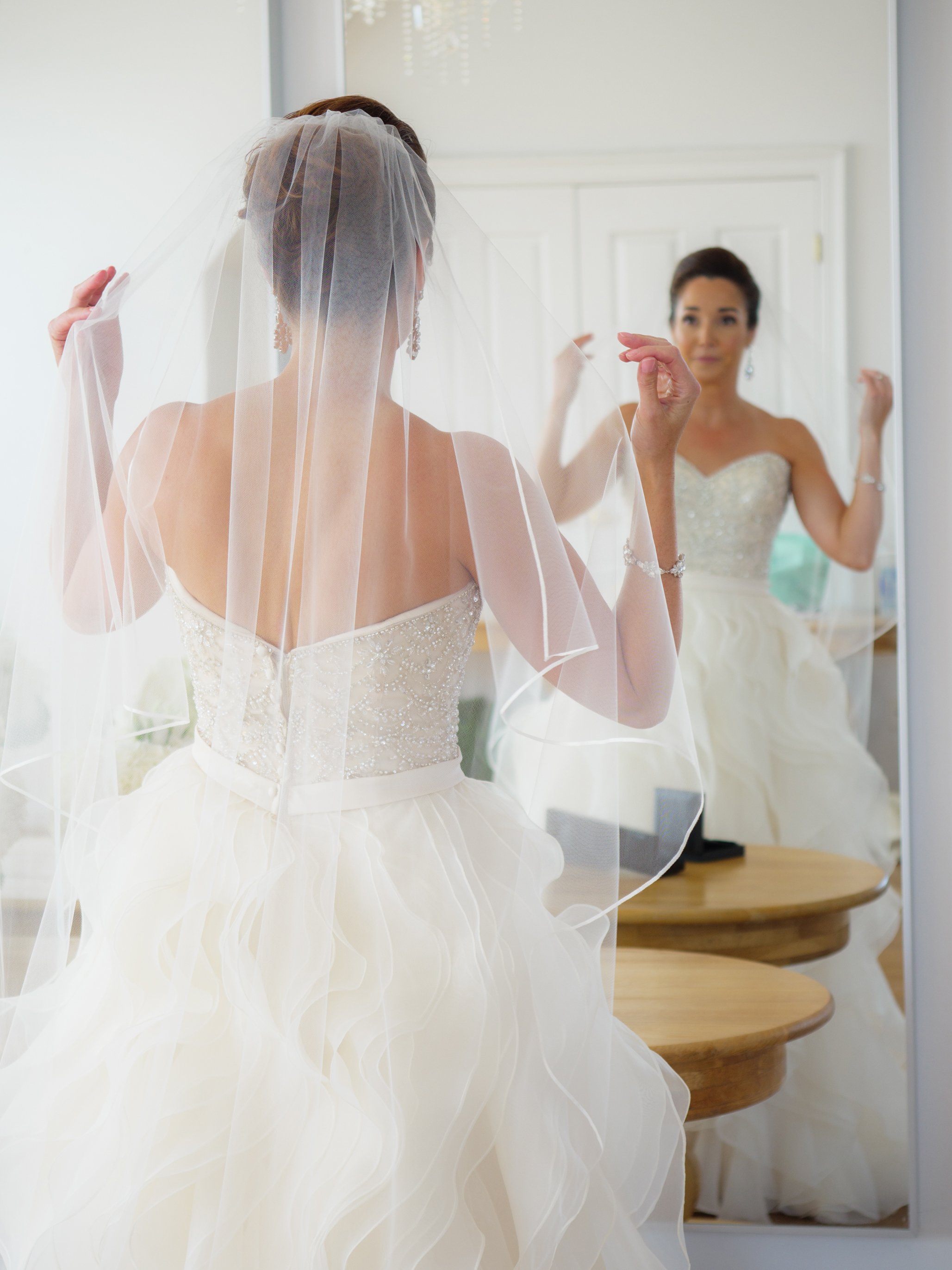 The bride adjust her wedding veil in the Island House at Belle Mer Newport RI
