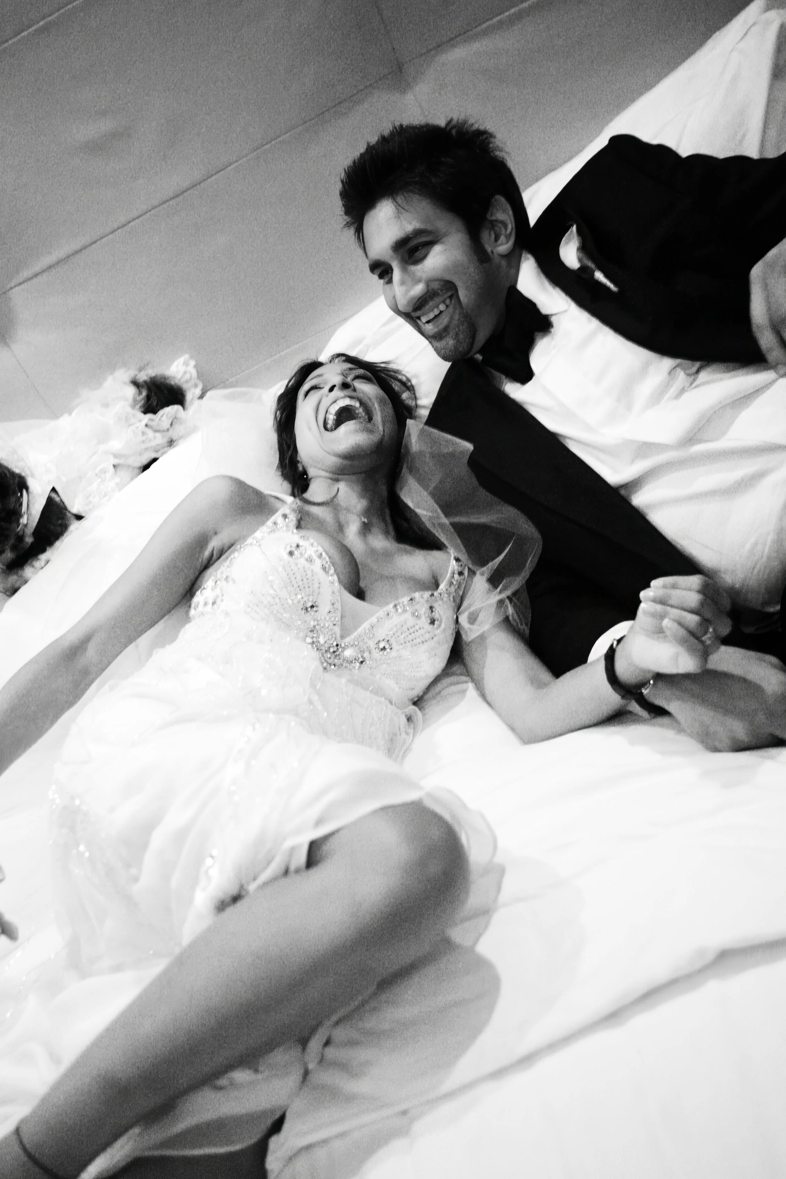 Black and white portrait of bride and groom in a suite at The Ritz-Carlton South Beach with a classic rock and roll aesthetic.