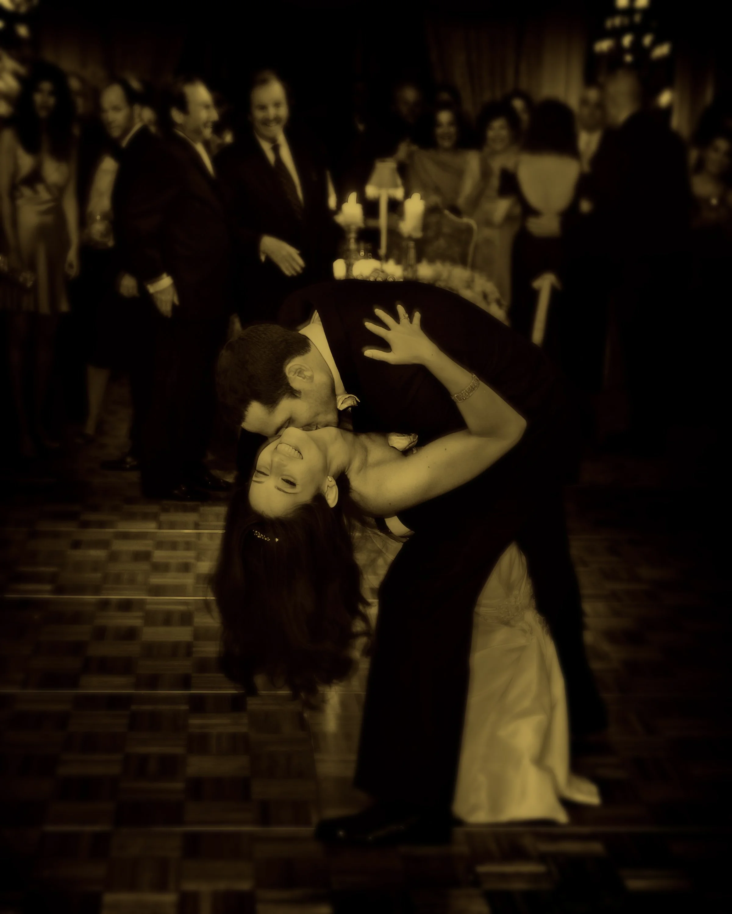Fine art split-tone photograph of the bride and groom sharing a dramatic dip kiss at The St. Regis New York ballroom.