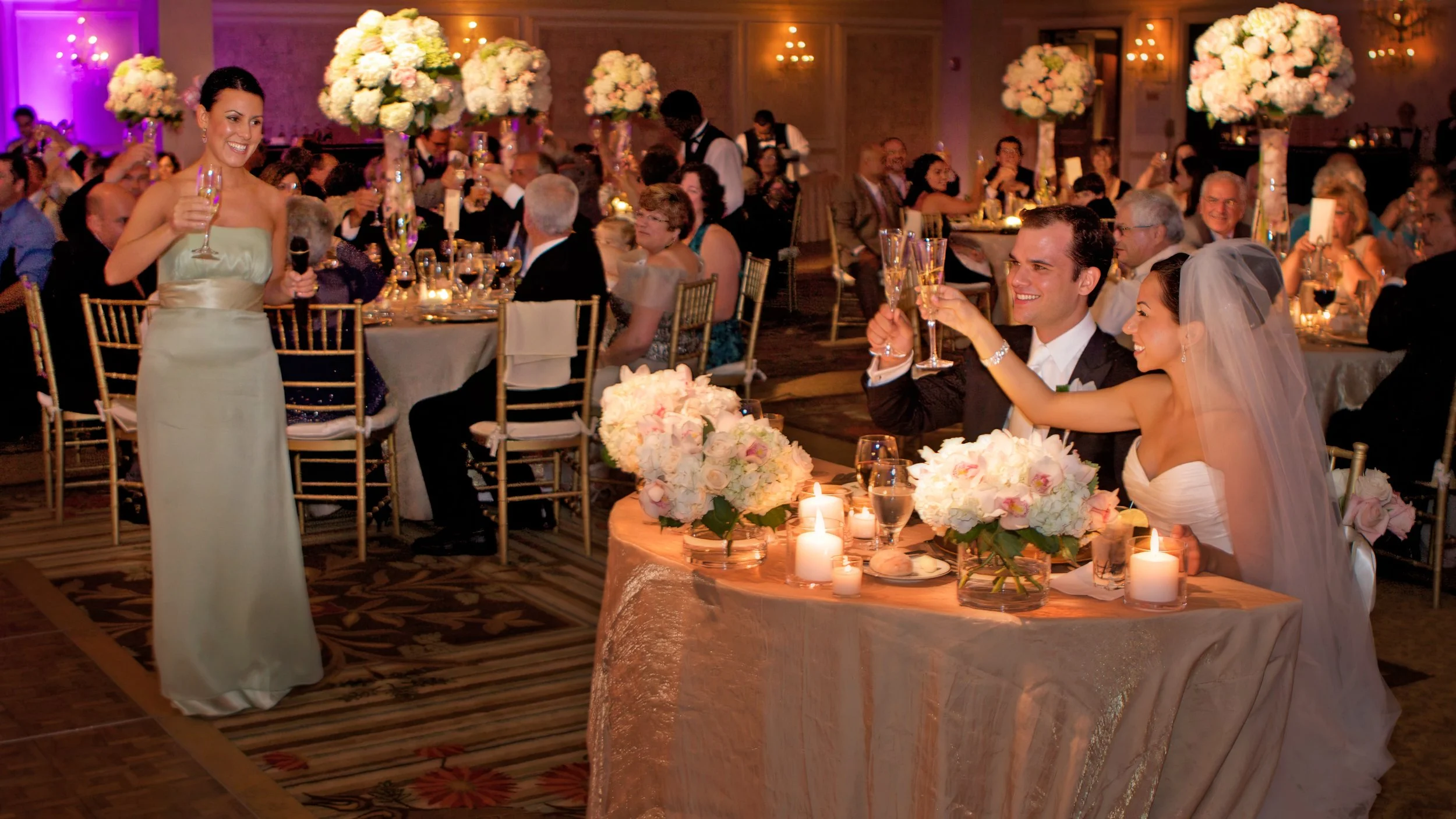 Bride and groom raise a glass during bridesmaids toast at Omni Hotel New Haven.
