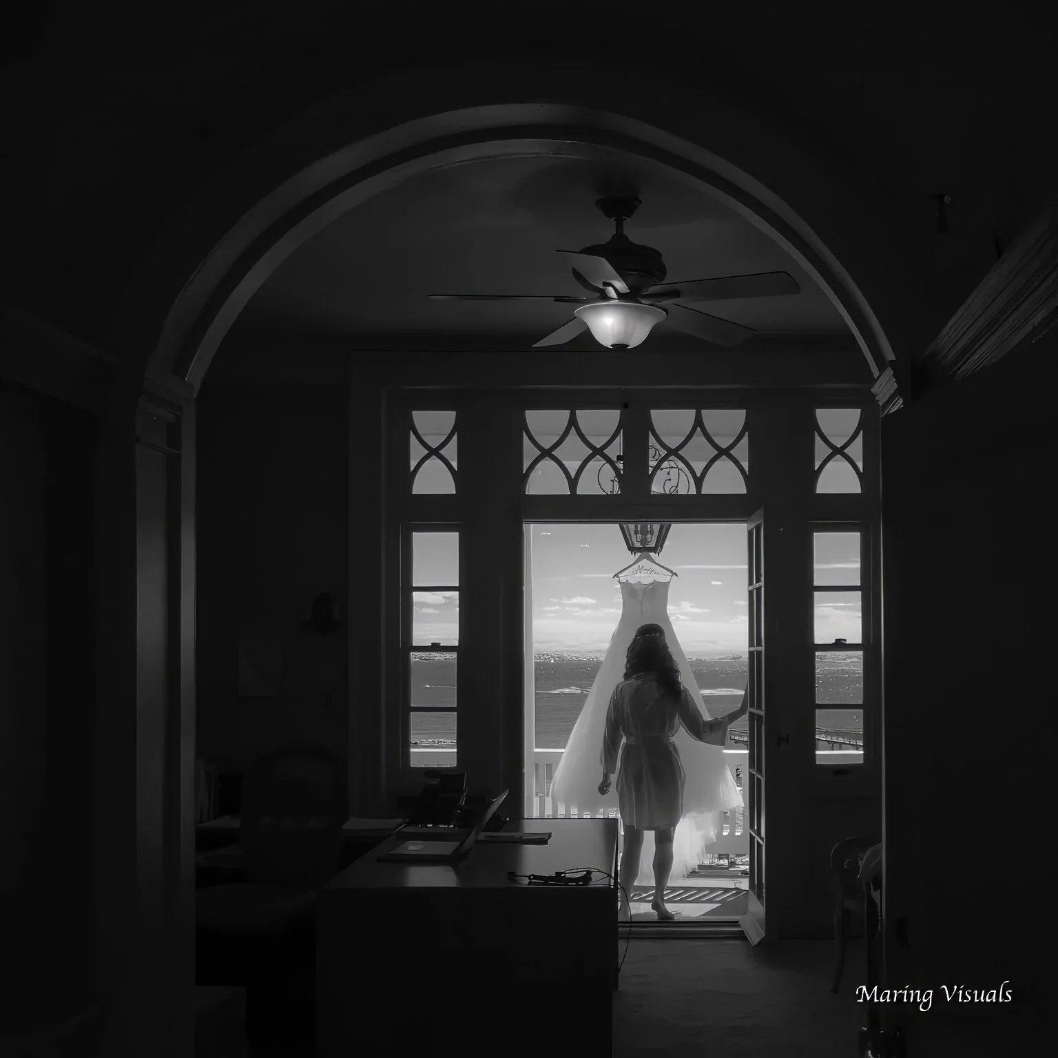 Bride looks at her wedding dress on the terrace of the Coveleigh Club