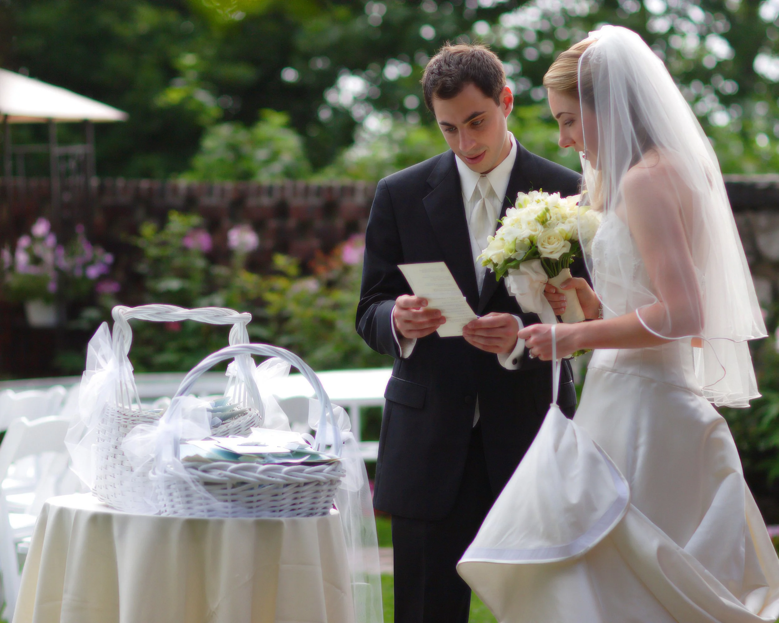 Bride and groom share a quiet moment reading their wedding ceremony programs together