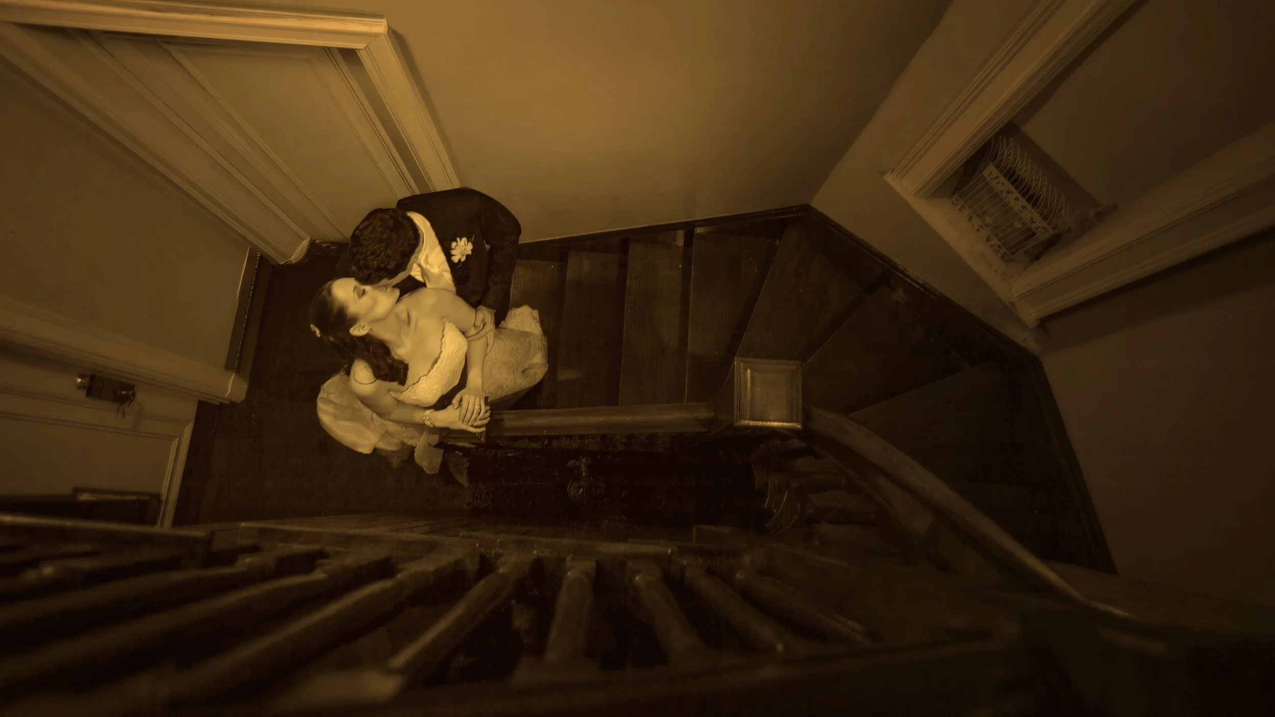 Fine art photograph of a kiss on the staircase at Ocean Cliff.