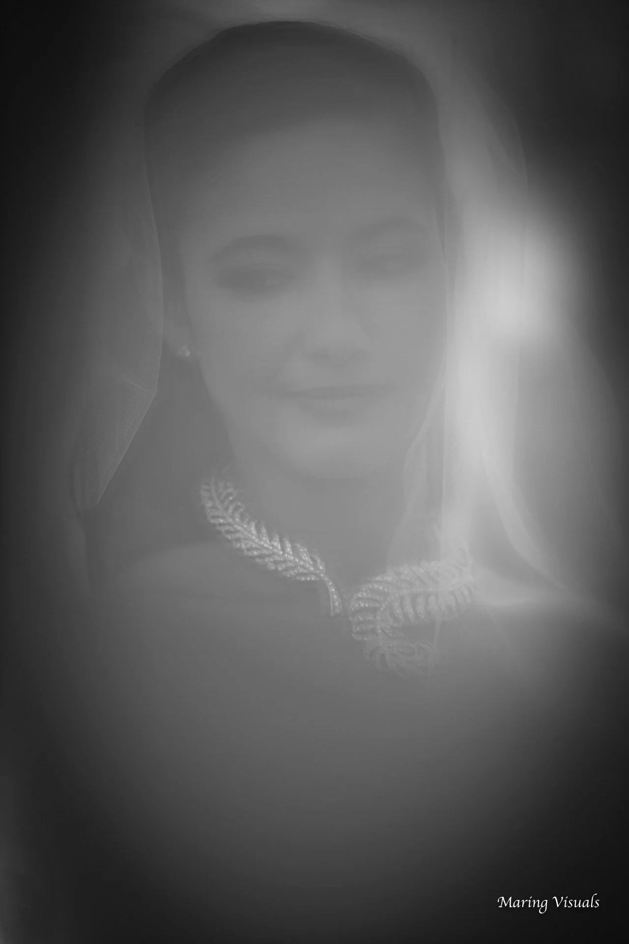 Bride photographed through blowing thule fabric during her wedding ceremony at Saint Clements Castle in Portland, Connecticut.