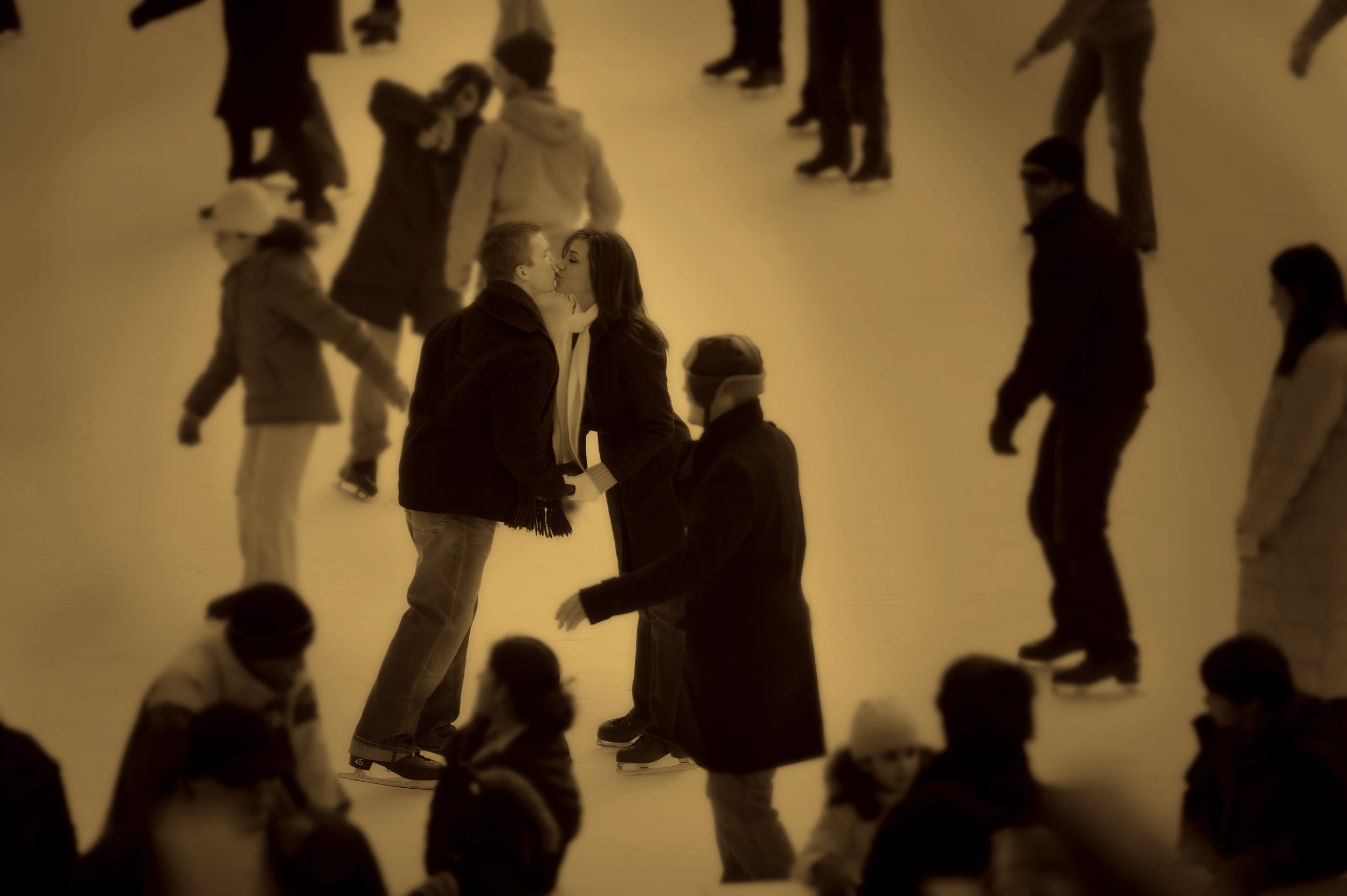 An engagement photo of a couple ice skating at Wollman Rink NYC