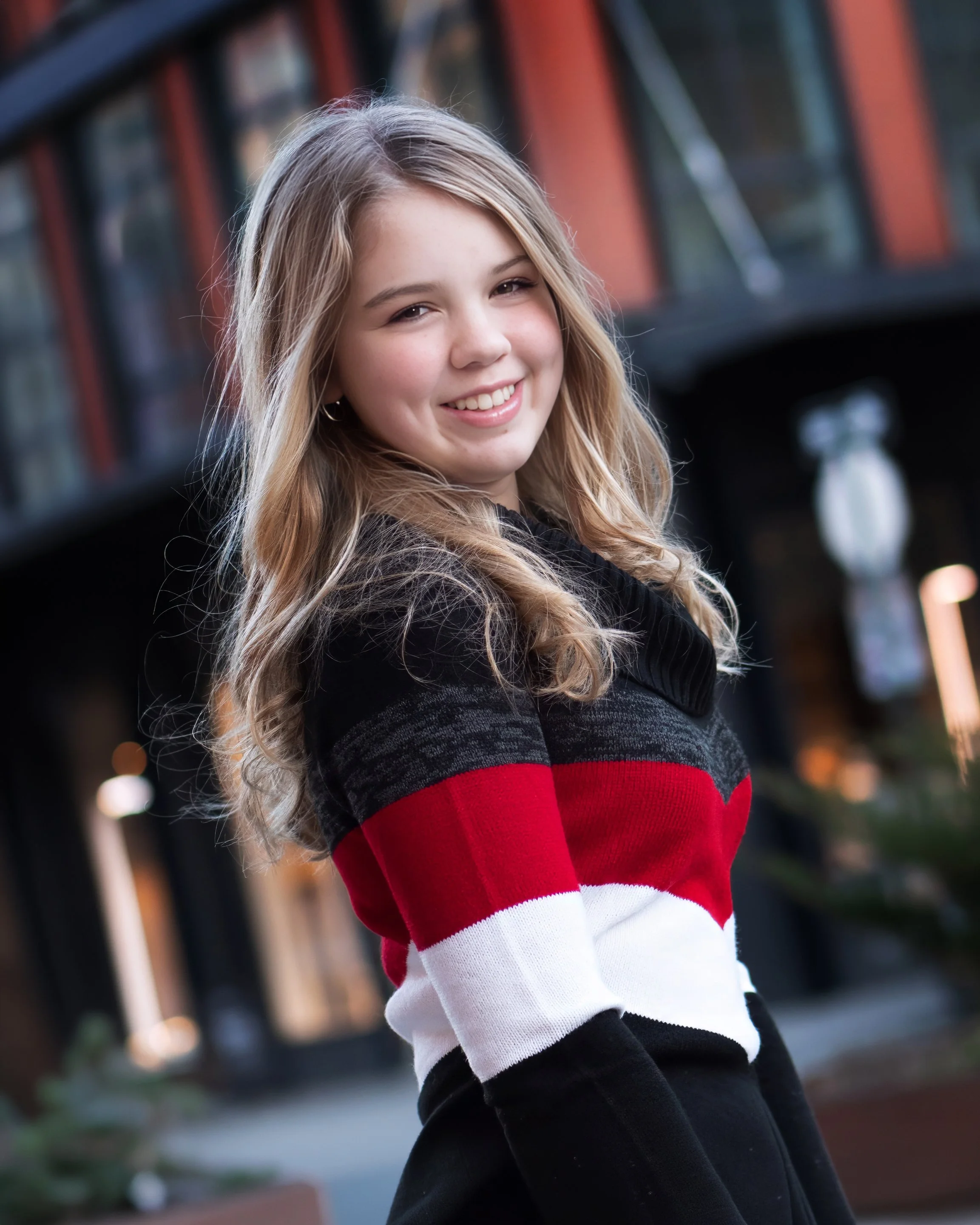 Headshot of a senior in the Meatpacking District of New York City, highlighting facial expression and personality.