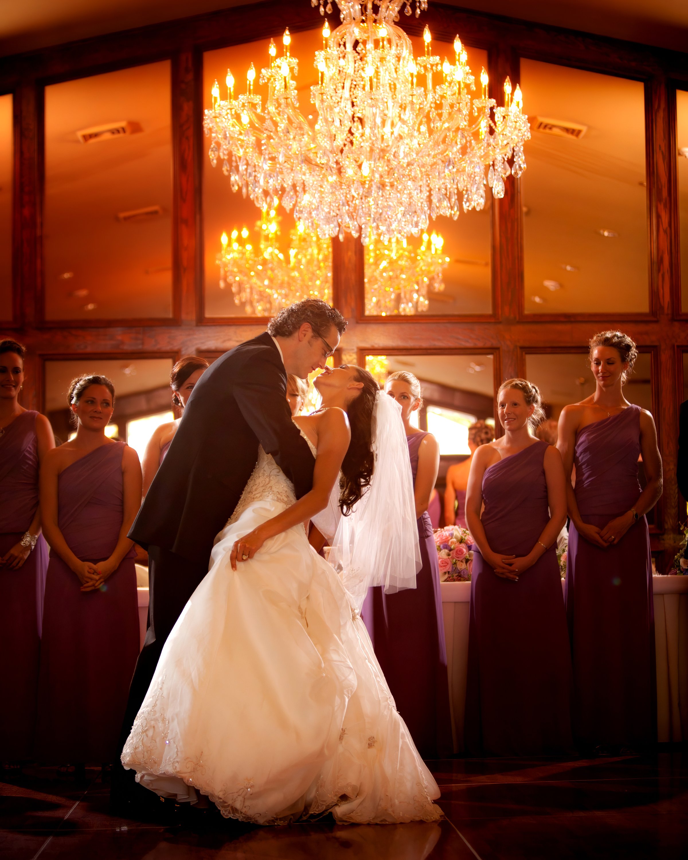 Groom dips the bride for a kiss at the end of their first dance at Saint Clements Castle.