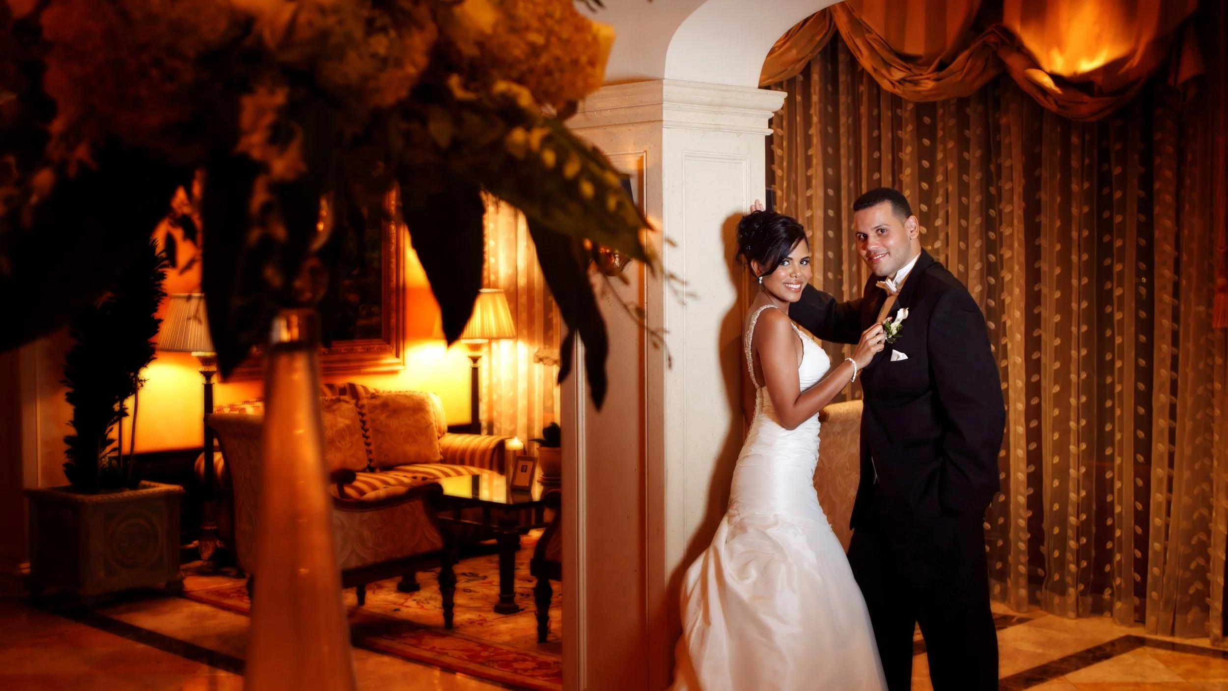 Bride and groom pose for an elegant portrait in the grand lobby of Delamar Greenwich Harbor.