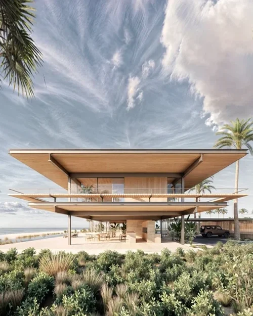Vivienda unifamiliar elevada en entorno costero, con estructura de madera, cubierta plana y espacios exteriores abiertos.