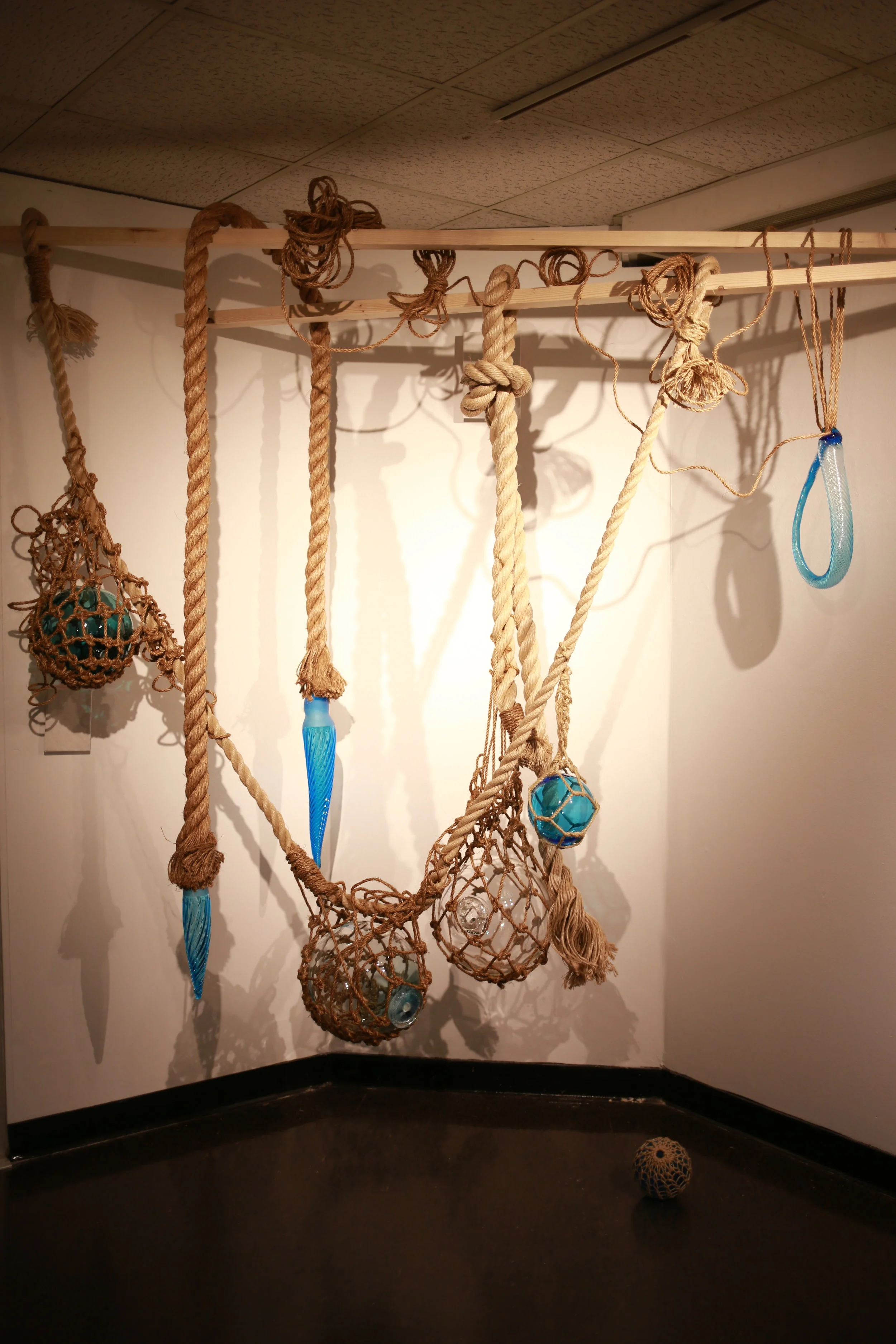  Slack ✤ 2015-16 ✤ Blown glass and ropes  The source of inspiration was a childhood favorite object, a Japanese buoy. The object originally belonged to Momoko's grandfather, and it served as an introduction to hand blown glass. The ethereal yet ancho