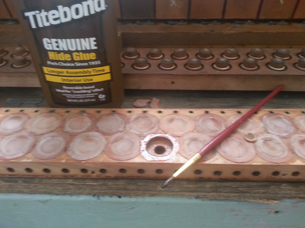 A small amount of hide glue applied to the outside of the pouch well.