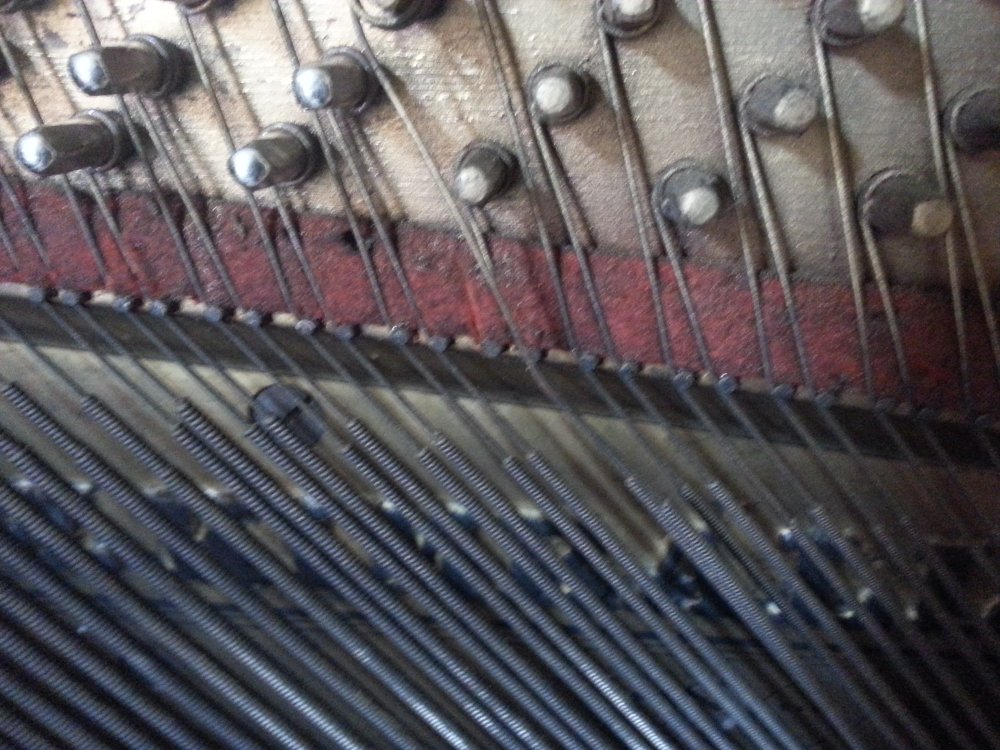 Releasing some tension by pulling the string off of the termination pin.