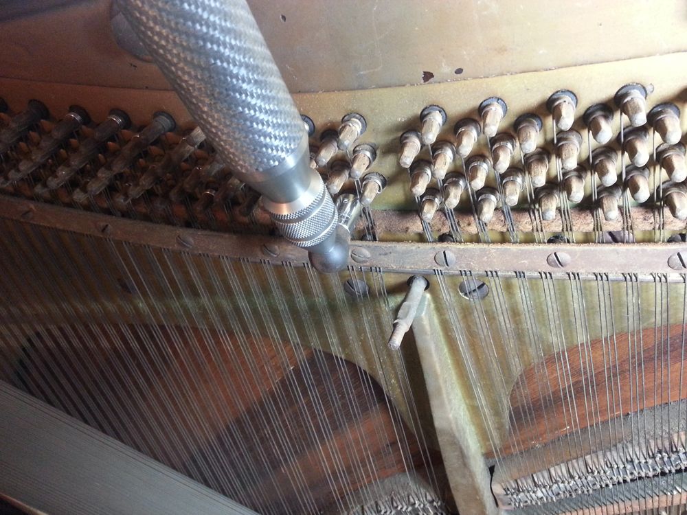 The strings that pass the offending bridge pins must be loosened slightly.