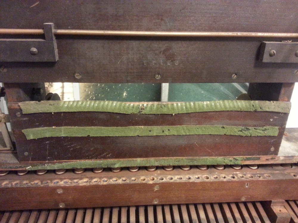 The backside of the spoolbox after removing the tracker bar. Notice the holes in the pouch board at the bottom of the photo where the lead tubing has been removed from.