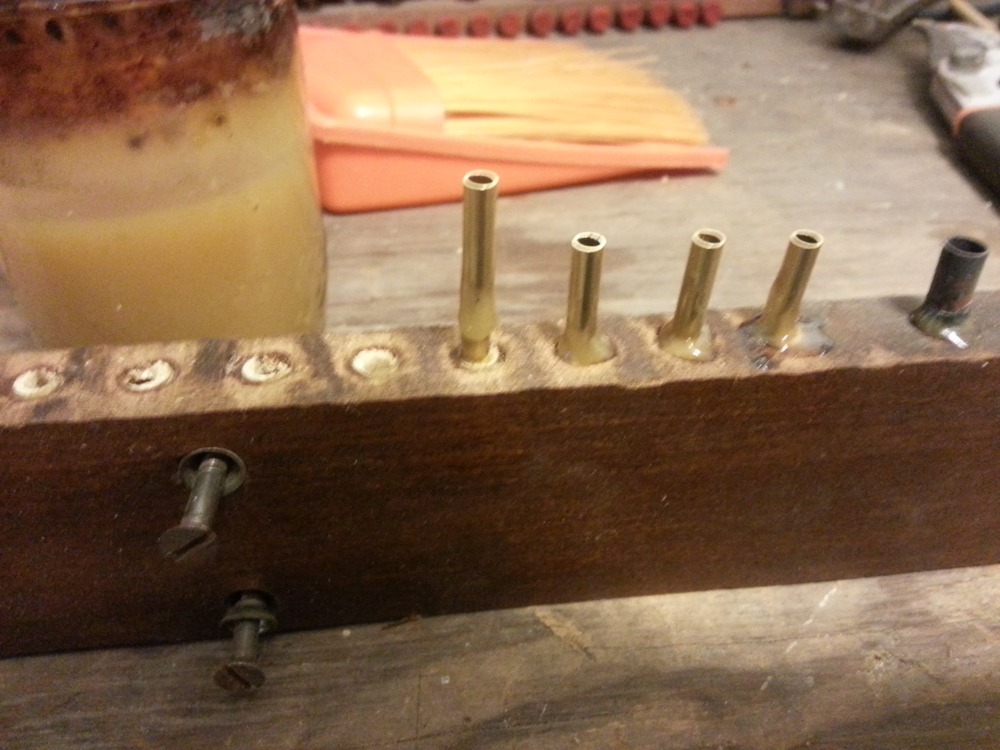Applying a drop of burnt shellac to the side of the brass connector.