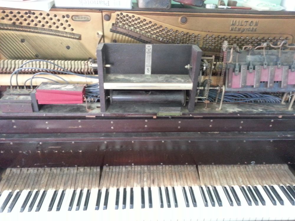 The upper stack of a player piano after replacing the lead tubing with new rubber tubing.