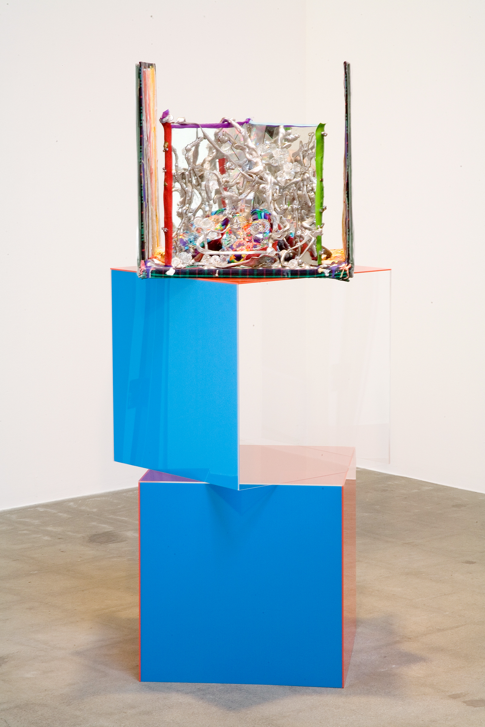  Ins and Outs of Digging Deep, 2006  plexiglass, mirror, paint, plastic, fabric, ribbons, liquid silver, glue, gold leaf, wax, clay, seeds, holographic stickers  54 X 25 1/2 X 25 1/2" / 137.2 X 65 x 65Cm    